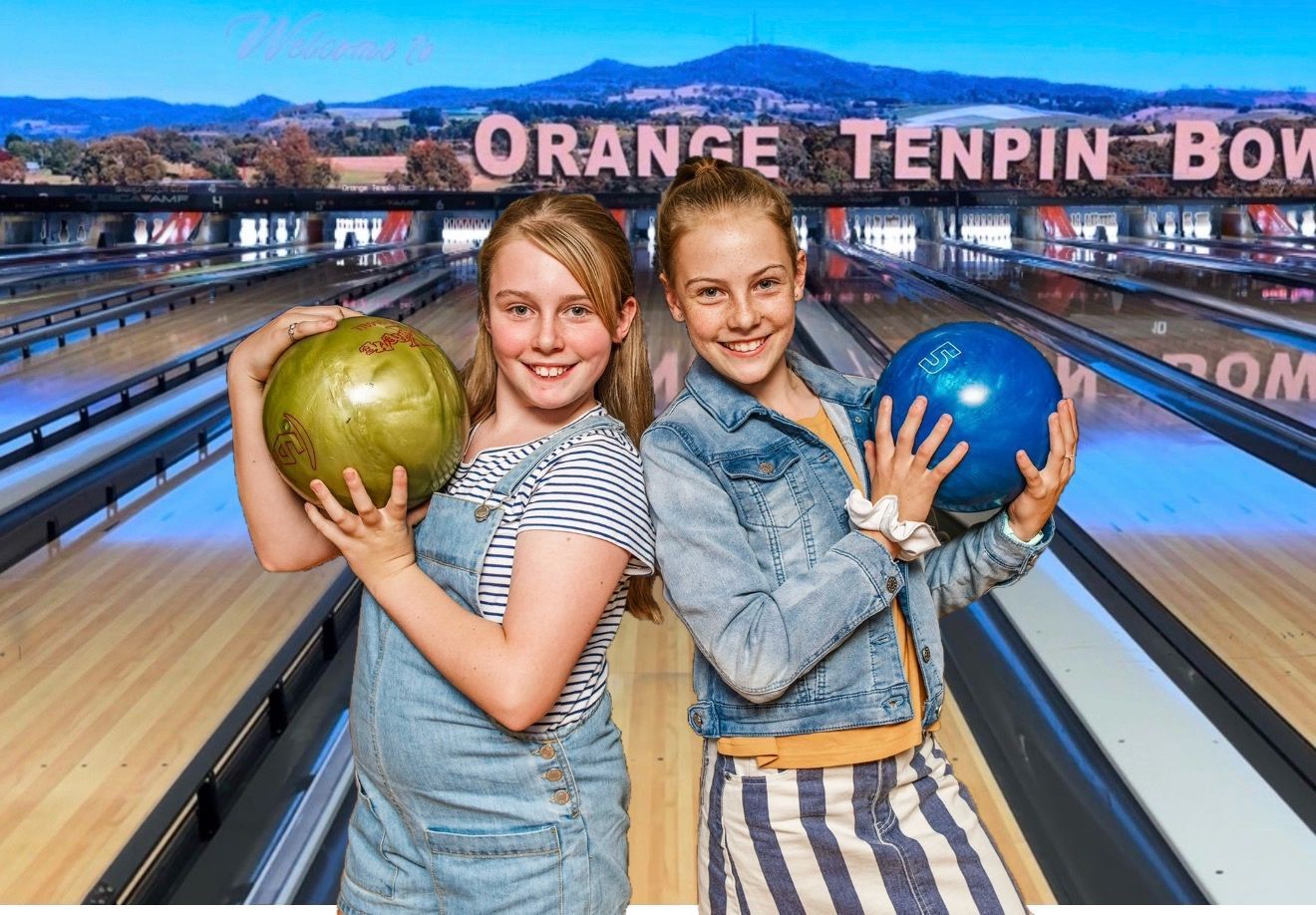 Two Bowlers Pose With Green and Blue Balls at a Bowling Alley — Orange Tenpin Bowl in Orange, NSW