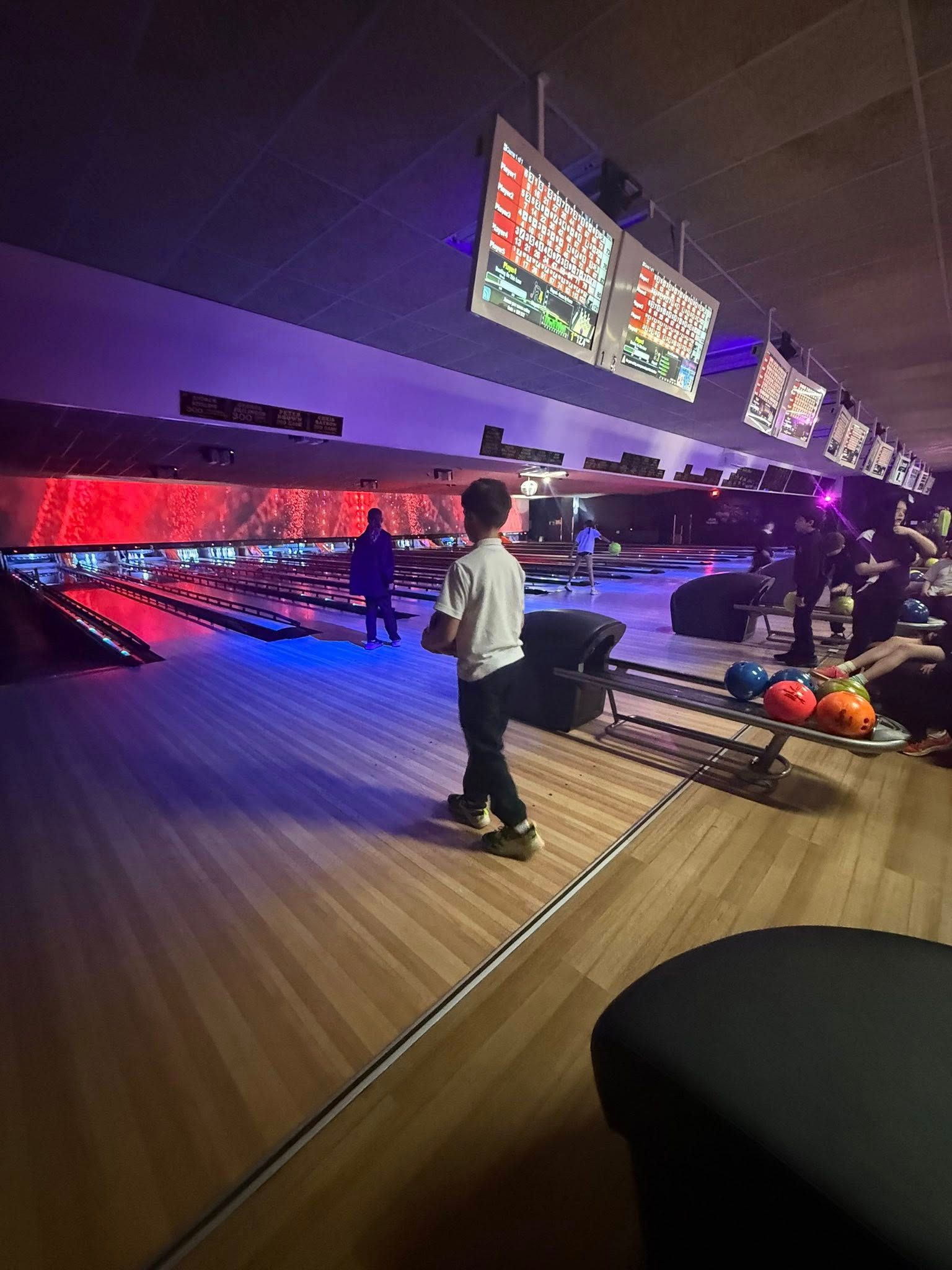 Person Standing at a Bowling Alley Lane With Scoreboards — Orange Tenpin Bowl in Orange, NSW