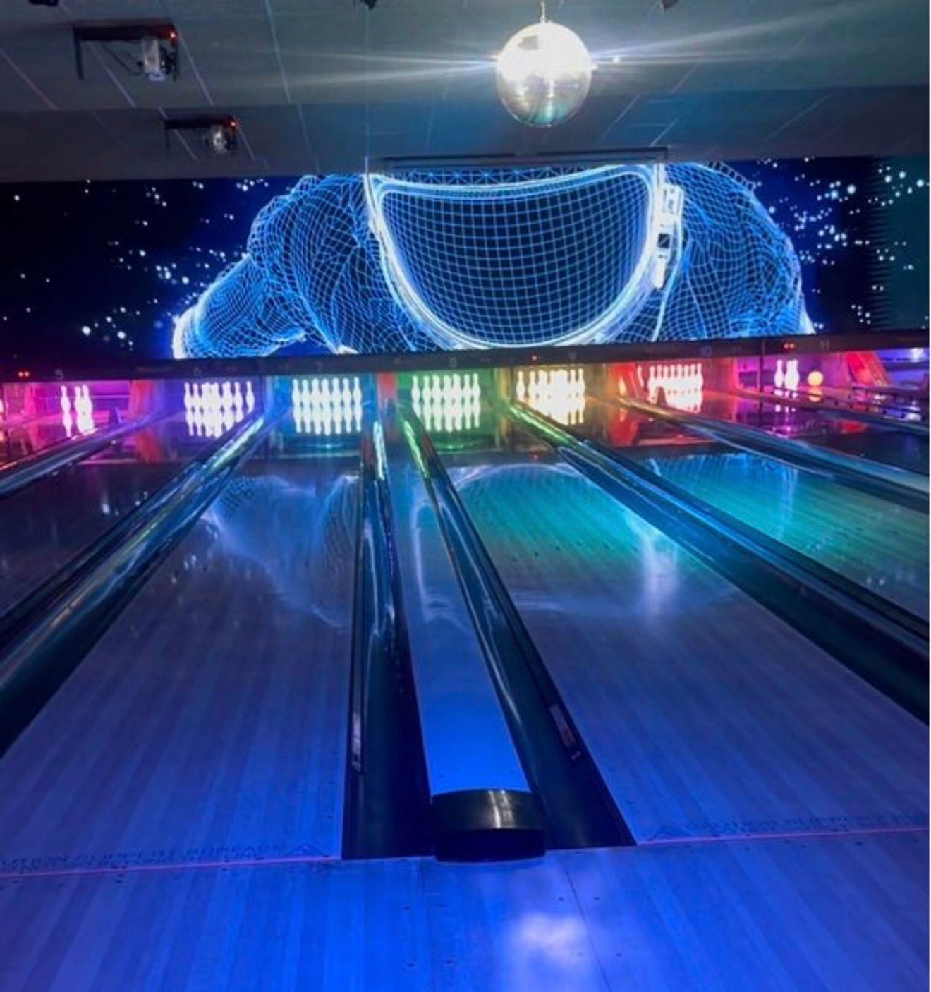 Neon-lit Bowling Alley With Glossy Lanes and a Blue Digital Mural at the Far End — Orange Tenpin Bowl in Orange, NSW