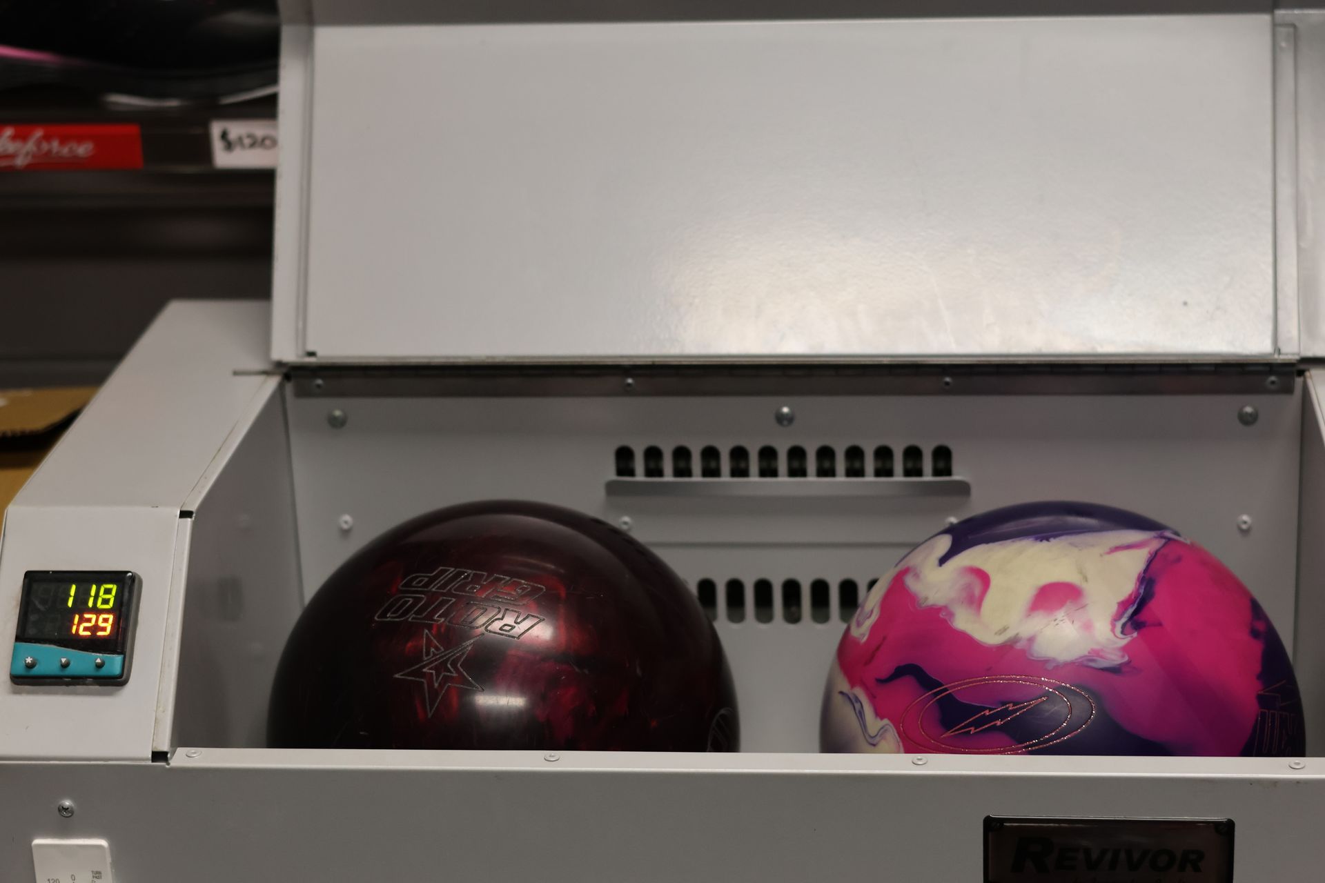 Two Bowling Balls Inside a Bowling Ball Return Machine, One Dark Red and One Pink-purple — Orange Tenpin Bowl in Orange, NSW