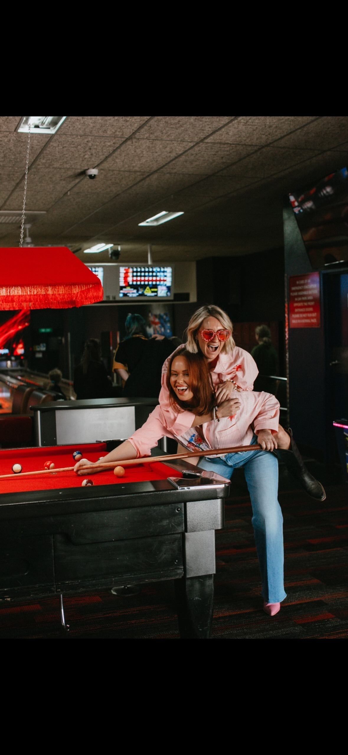 Two People Leaning Over a Pool Table in a Dim Arcade — Orange Tenpin Bowl in Orange, NSW