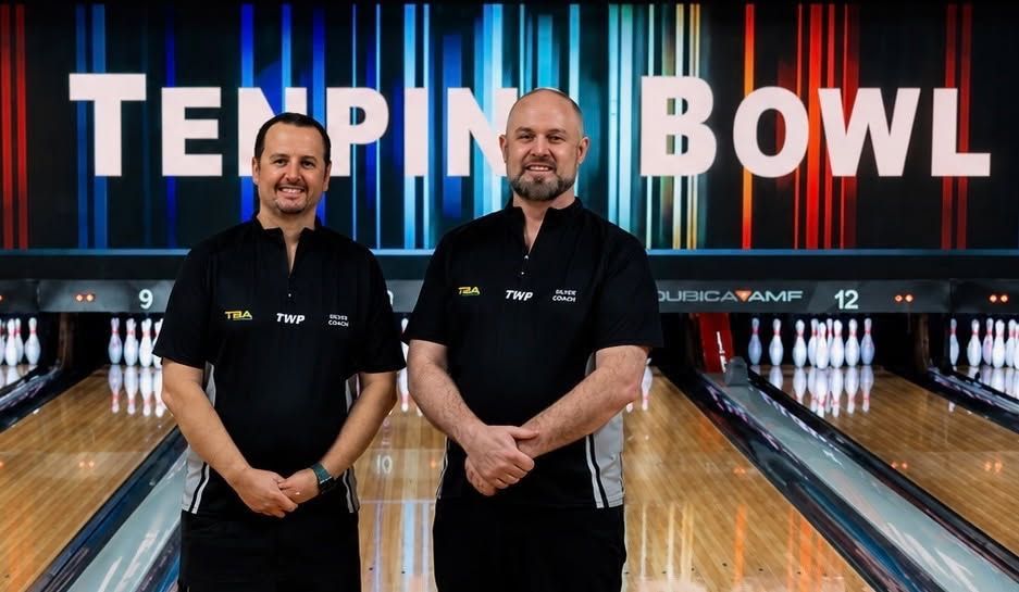 Two Men in Black Shirts Stand in a Bowling Alley Before a teppin Bowl Sign — Orange ten pin Bowl in Orange, NSW