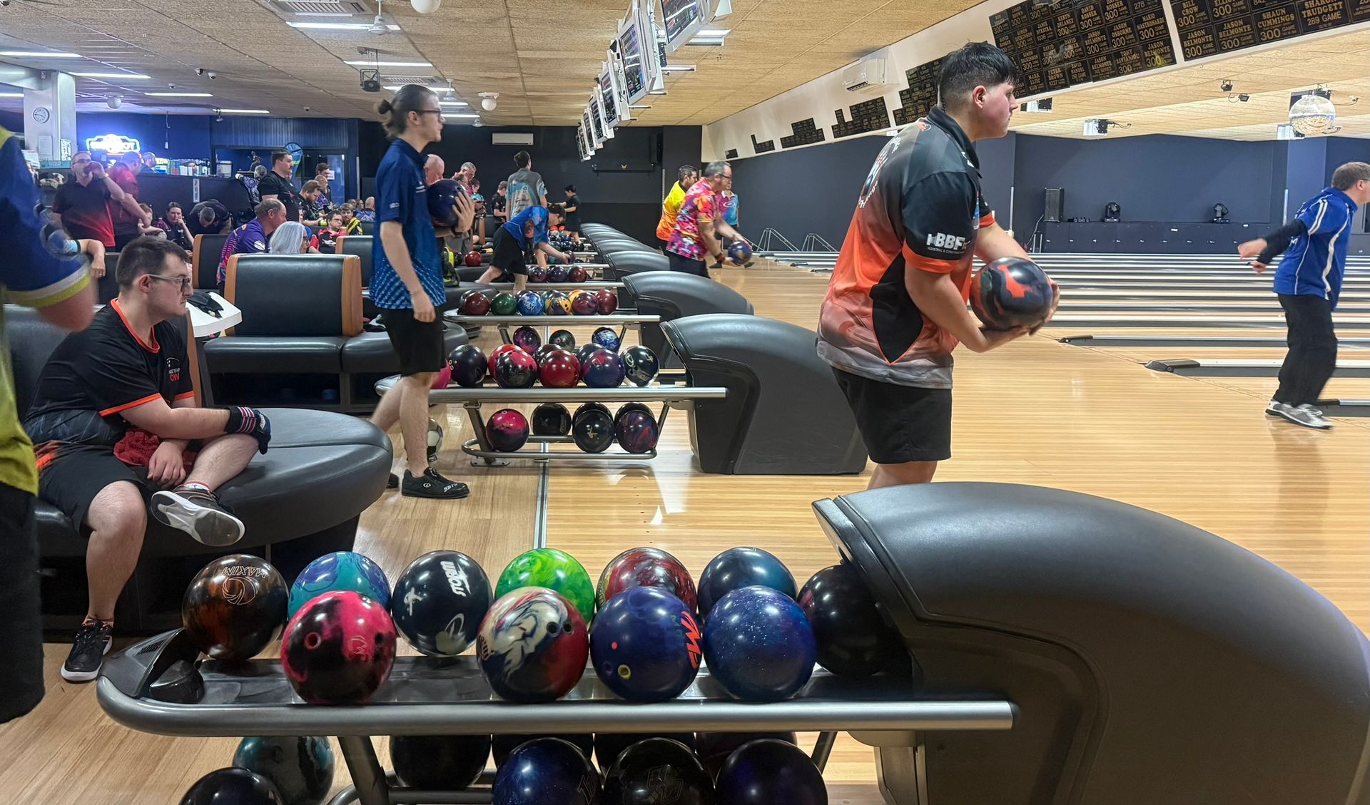 Bowling Alley With Players Lining Up Shots and Balls on Racks in the Foreground — Orange Tenpin Bowl in Orange, NSW