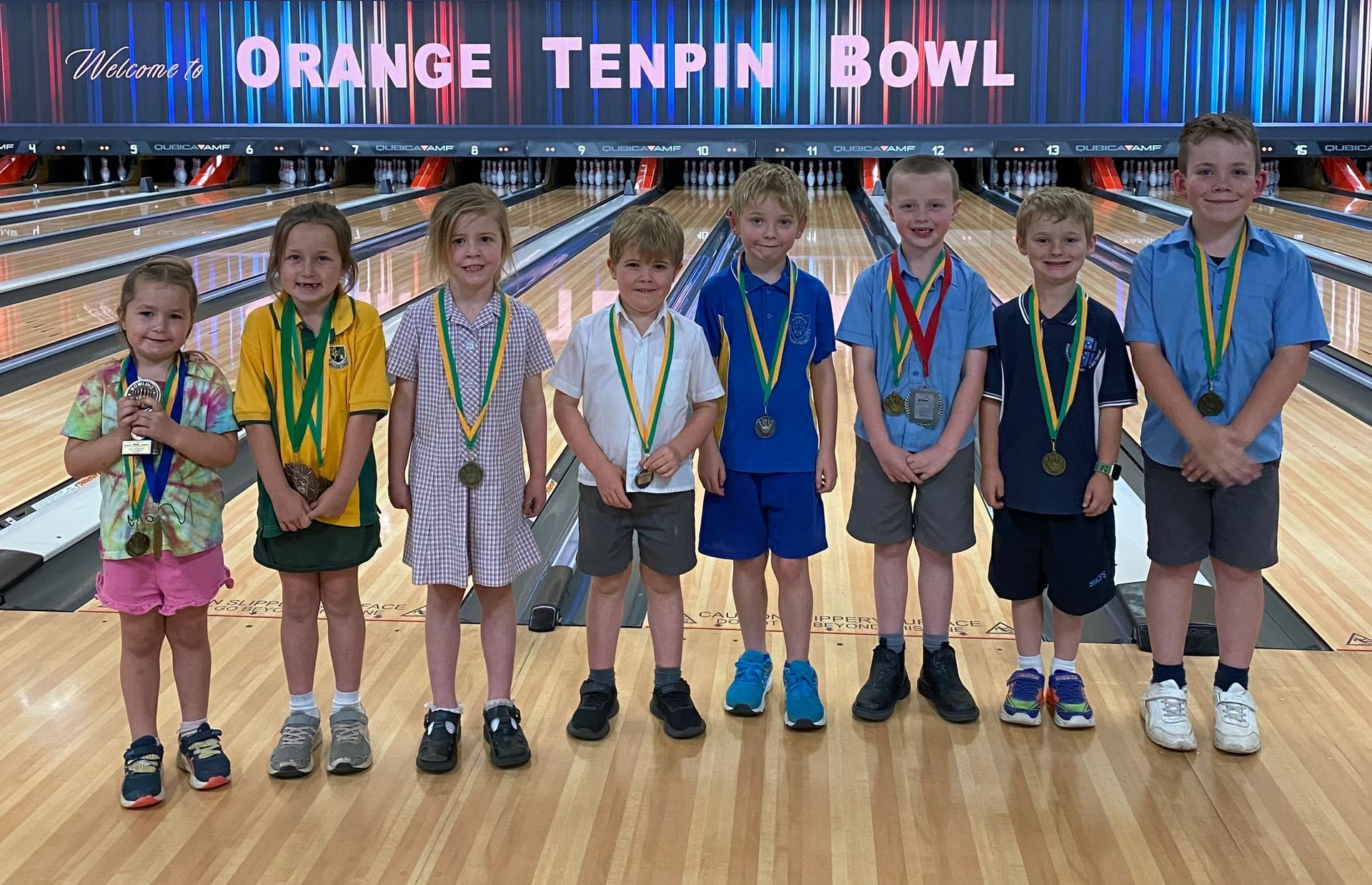 Group of Children Standing on a Bowling Lane, Wearing Medals — Orange Tenpin Bowl in Orange, NSW