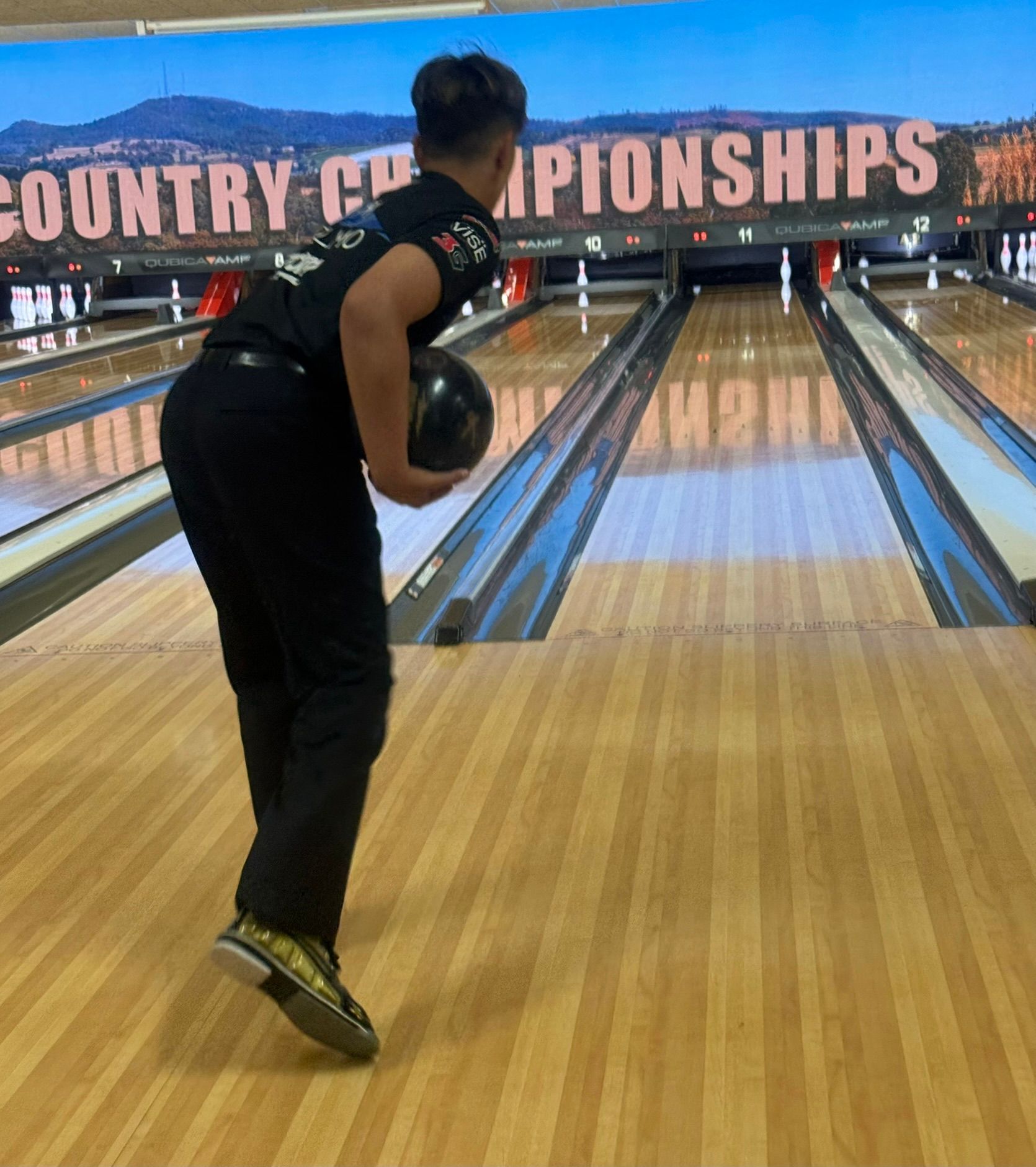 Bowler in Black Uniform Releasing a Bowling Ball on a Lane at Country Championships — Orange Tenpin Bowl in Orange, NSW
