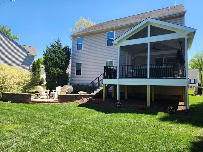 Backyard with a screened porch, deck, and patio area.