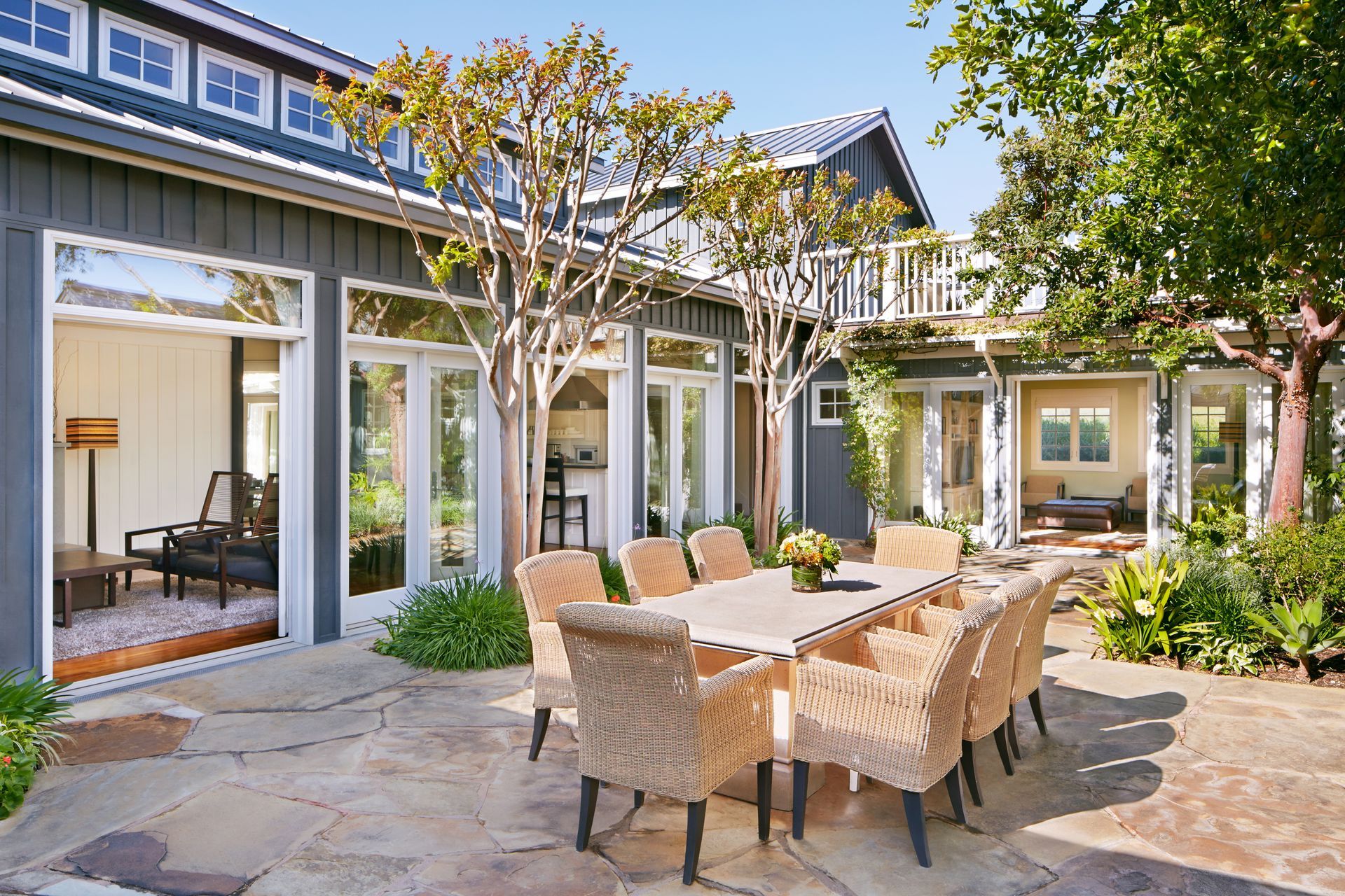 A backyard with a dining room table showcasing residential hardscaping services. A backyard with a dining room table showcasing residential hardscaping services.