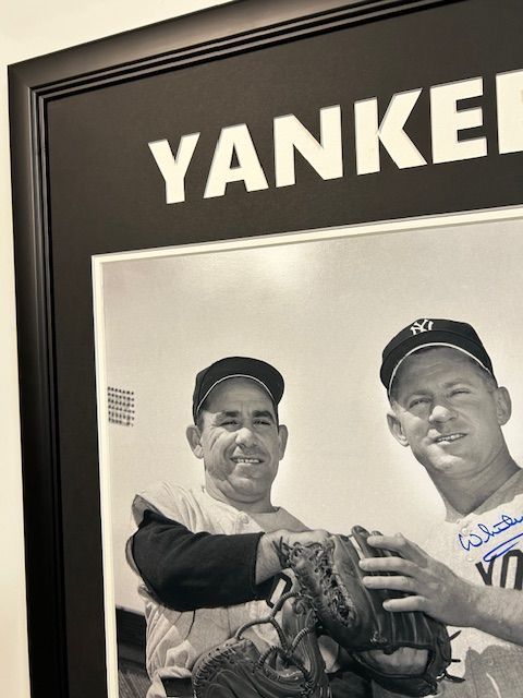 Framed black-and-white Yankees photo with a player wearing a cap and glove, signed in blue ink