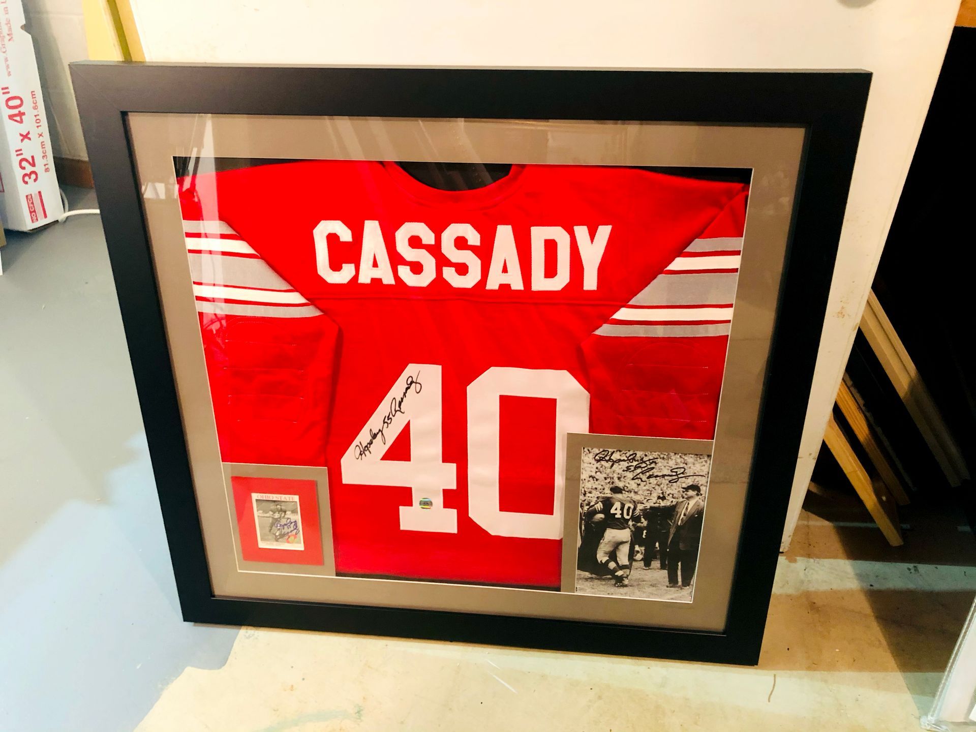 Framed red football jersey reading “CASSADY” and number 40, displayed with small photos