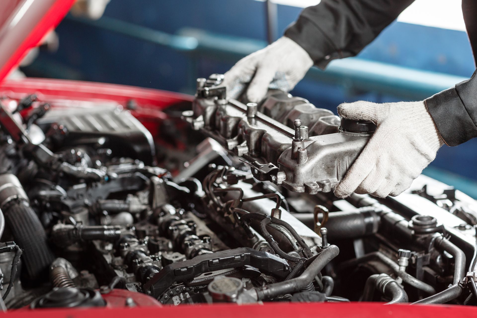 Car mechanic looking at engine for analysis symptoms of car at maintenance repair service station.