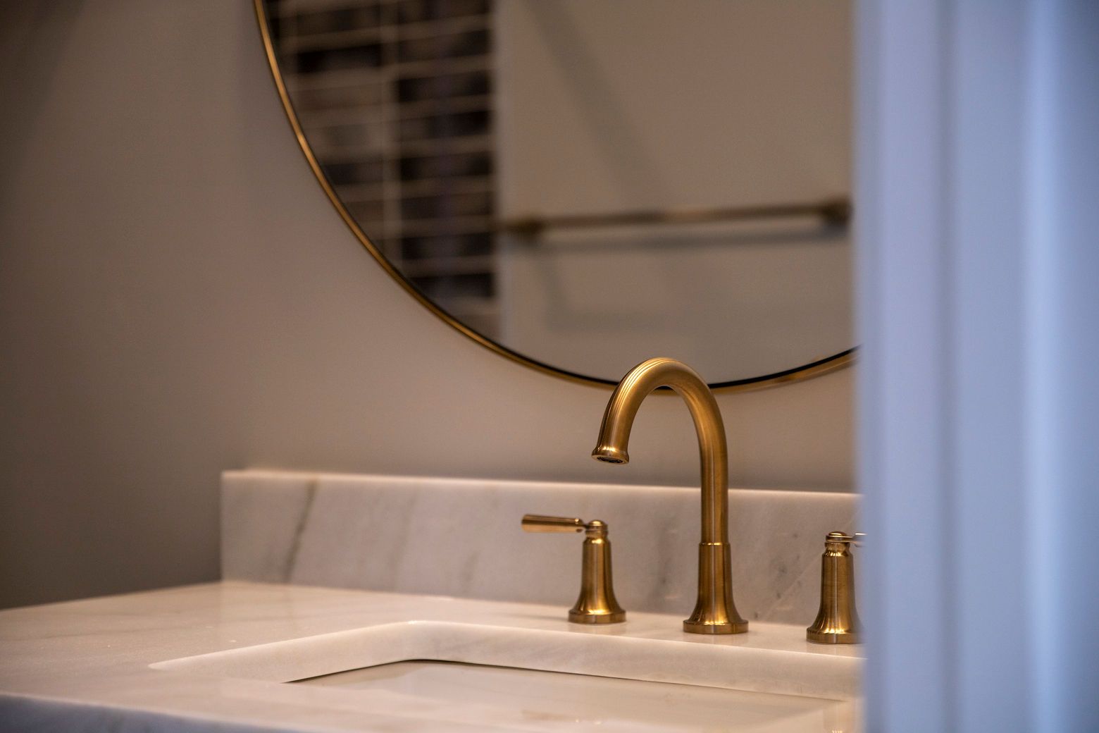 Custom bathroom vanity with a marble countertop and a stylish mirror.