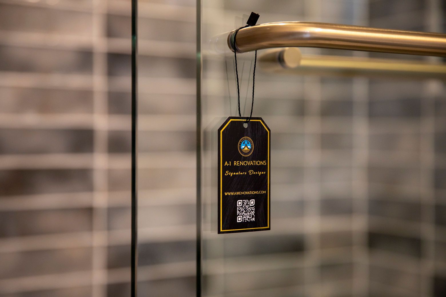 Modern hall bathroom remodel with a custom walk-in shower, patterned tile, and a gold-framed round mirror.