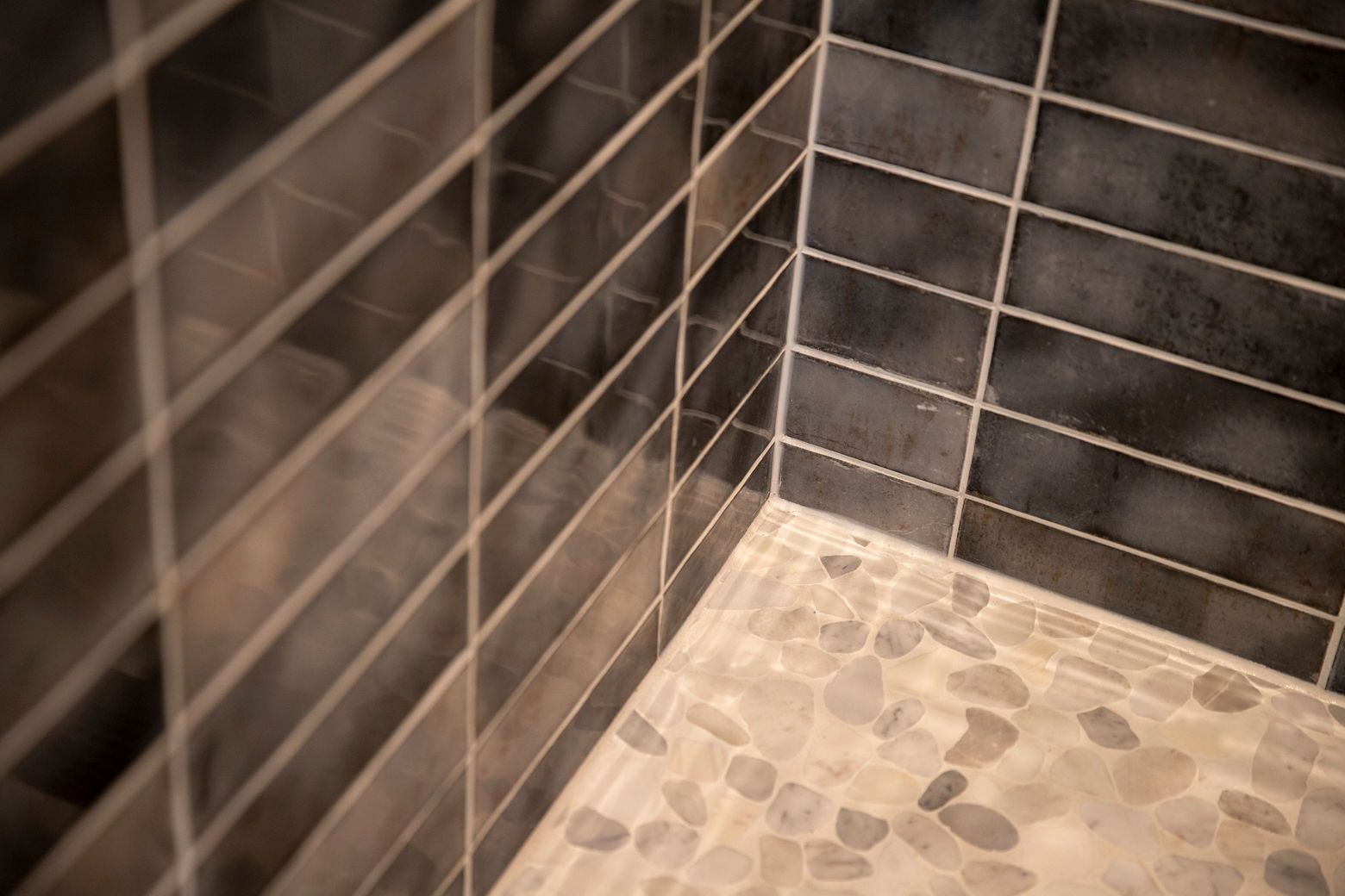 Modern hall bathroom remodel with a walk-in shower and elegant tile.