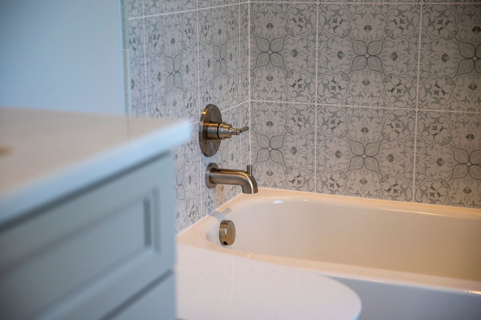  Westminster bathroom remodel with decorative tile, new vanity, and brushed nickel faucets.