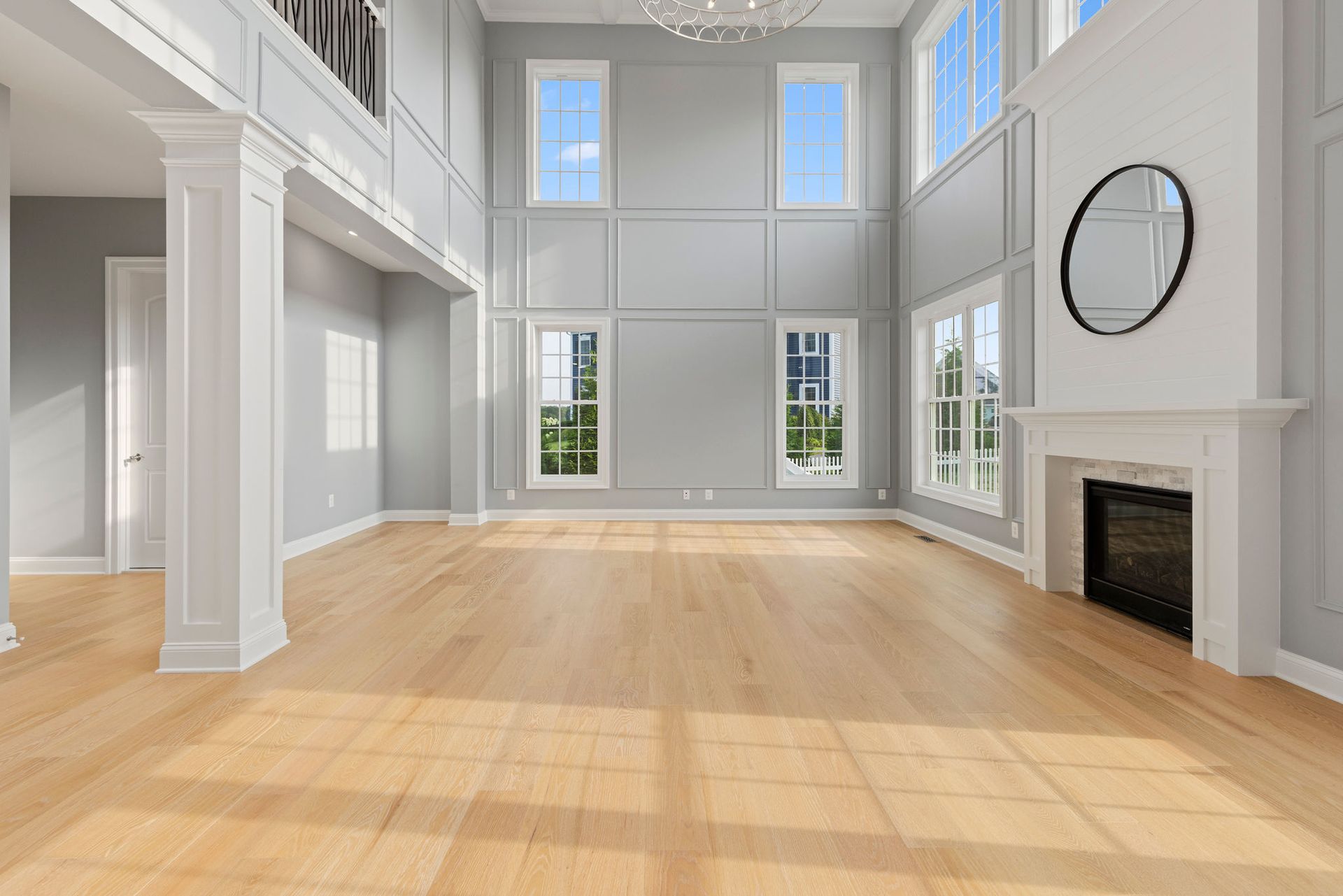 Structural renovation and open-concept design services, including column decoration and luxury hardwood flooring.