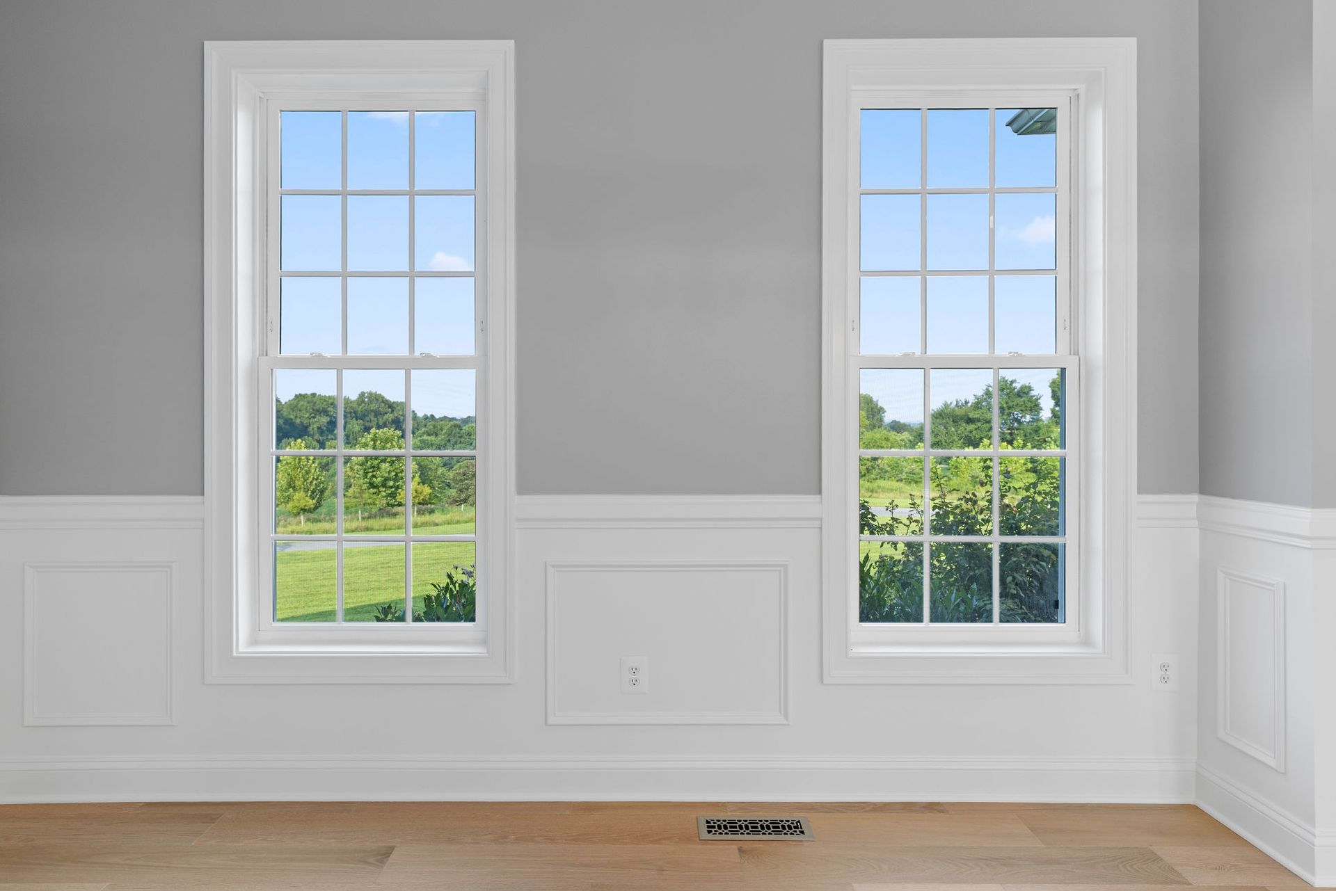 Interior design finishes: installing decorative wainscoting paneling and window casing for high-end residential appeal.