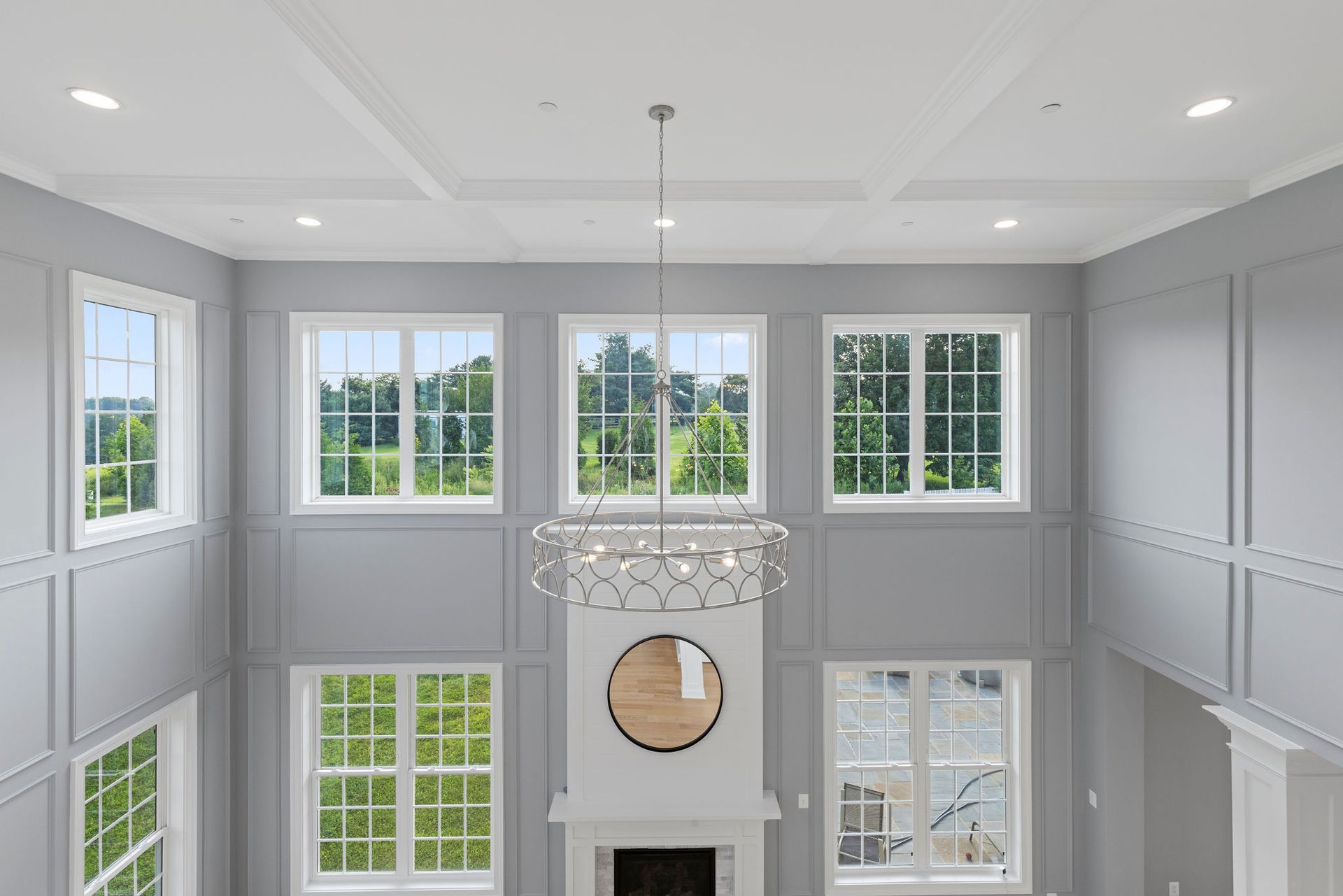 Two-story ceiling design: custom coffered ceiling and decorative wall molding for a dramatic living space.