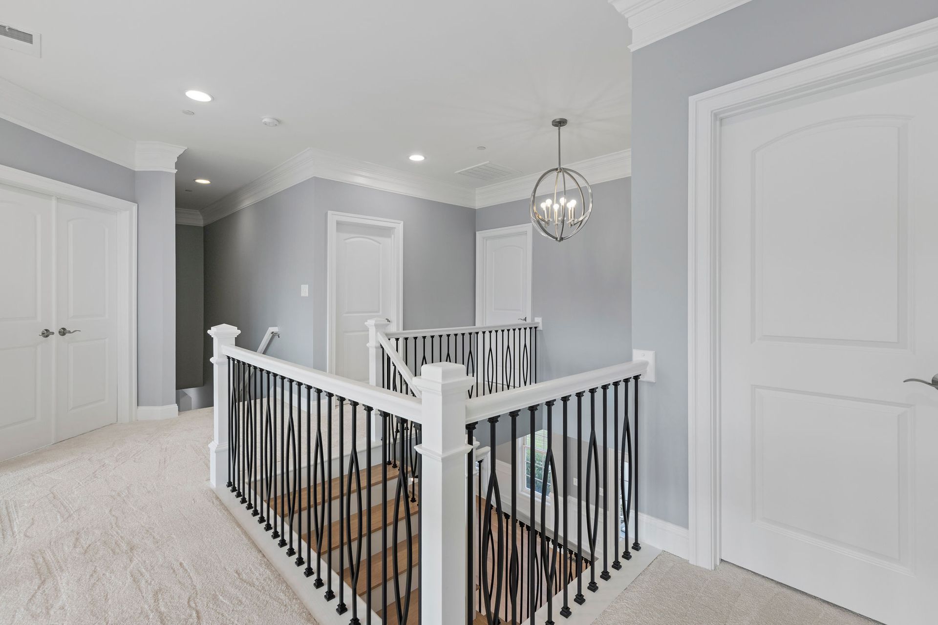 Upper hallway renovation: installing custom railing system, trim, and modern lighting fixtures.