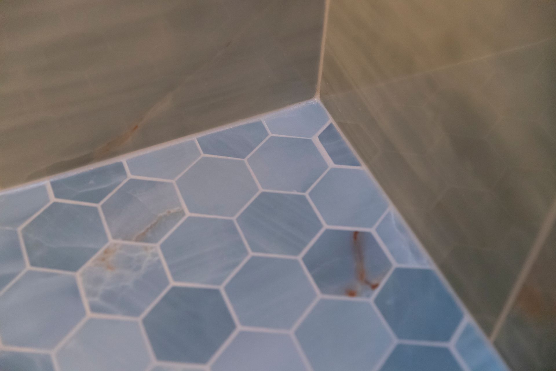 A close-up of the custom-sized shower footprint, showcasing the seamless transition from the main floor to the new shower base.