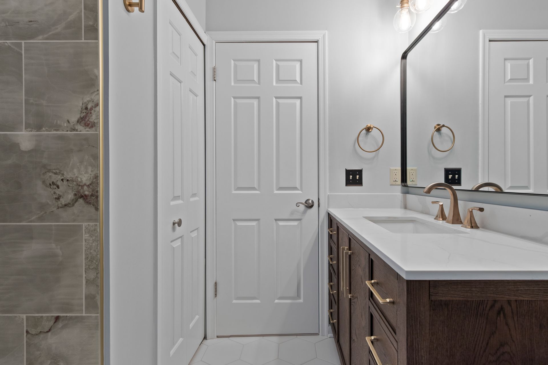 The transformation of a dated bathroom into a modern retreat with a custom-built shower and upgraded plumbing throughout.