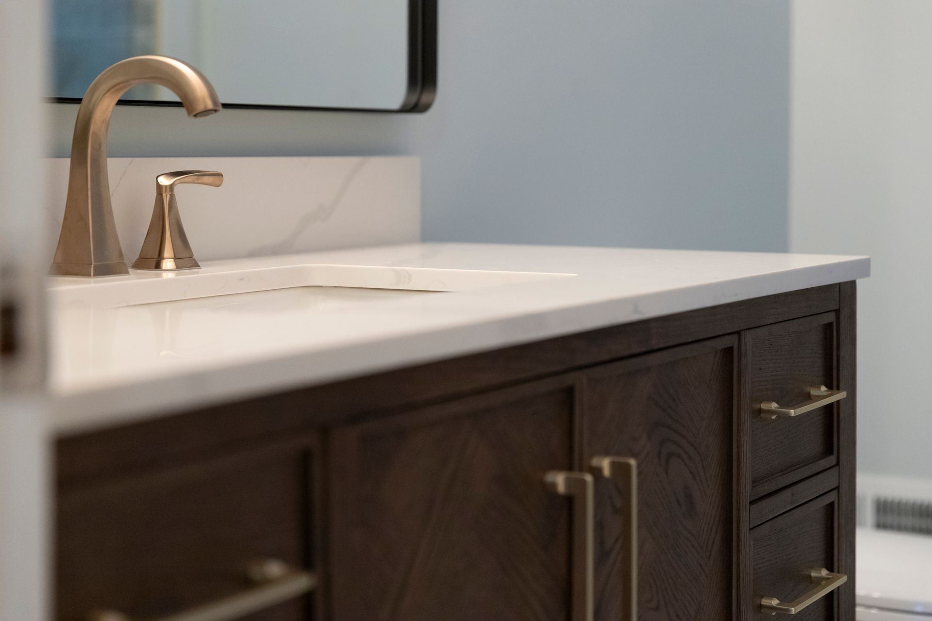 A stylish 48-inch centered sink vanity installation that maximizes storage and counter space in a remodeled Bel Air bathroom.