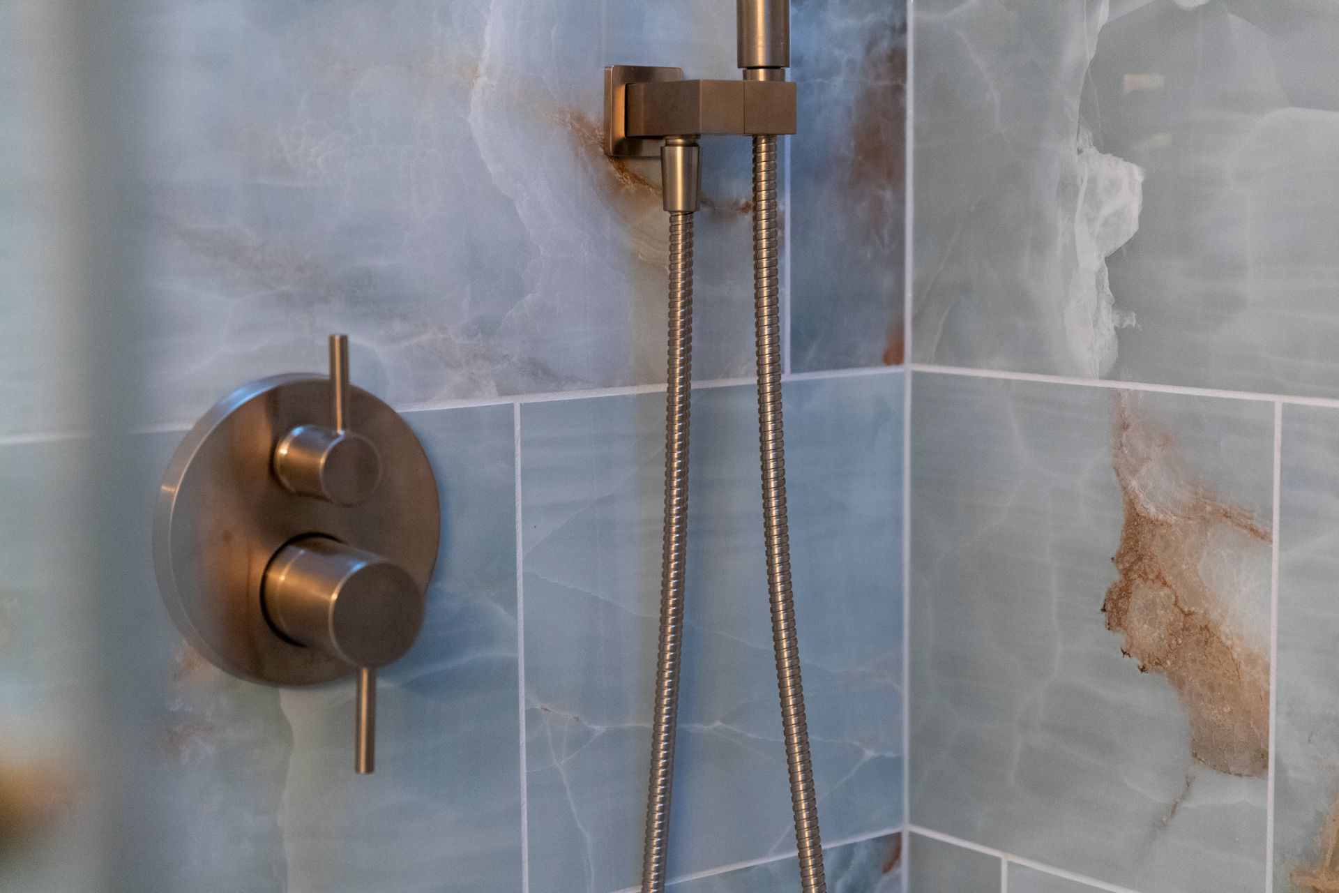 Brushed nickel shower fixtures.