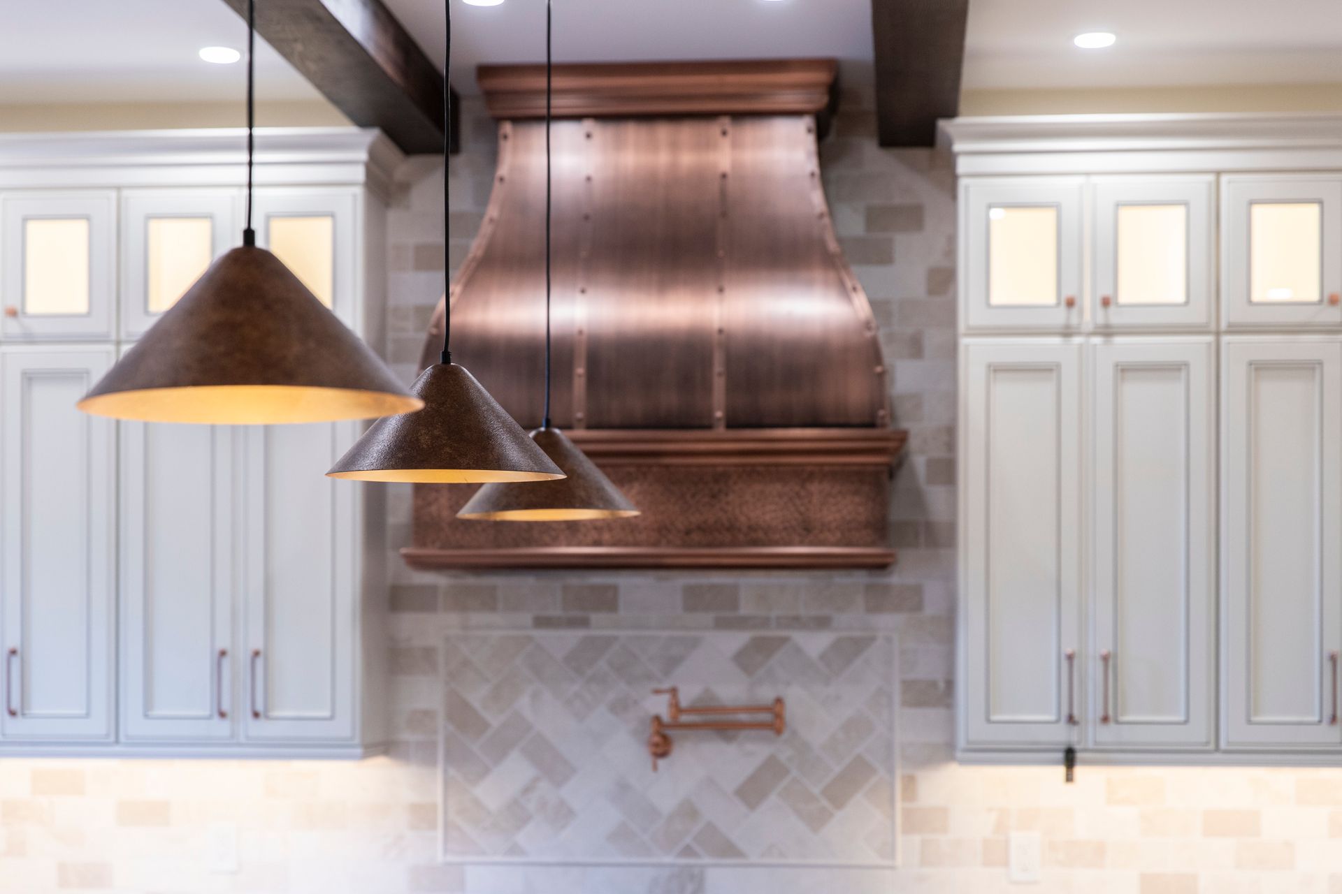 An angled shot of the bright kitchen, showcasing the sophisticated lighting scheme.