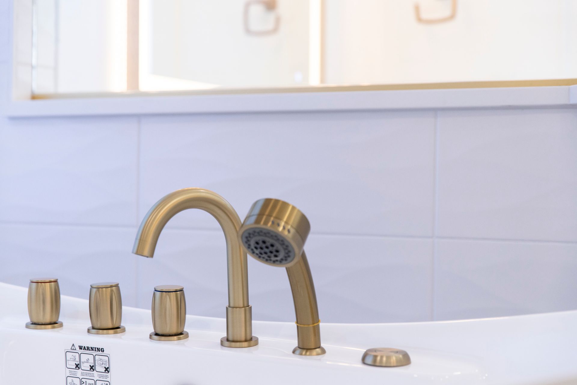 A detail shot of the new gold tub filler and faucet, showcasing the high-quality fixtures in Cockeysville, MD.