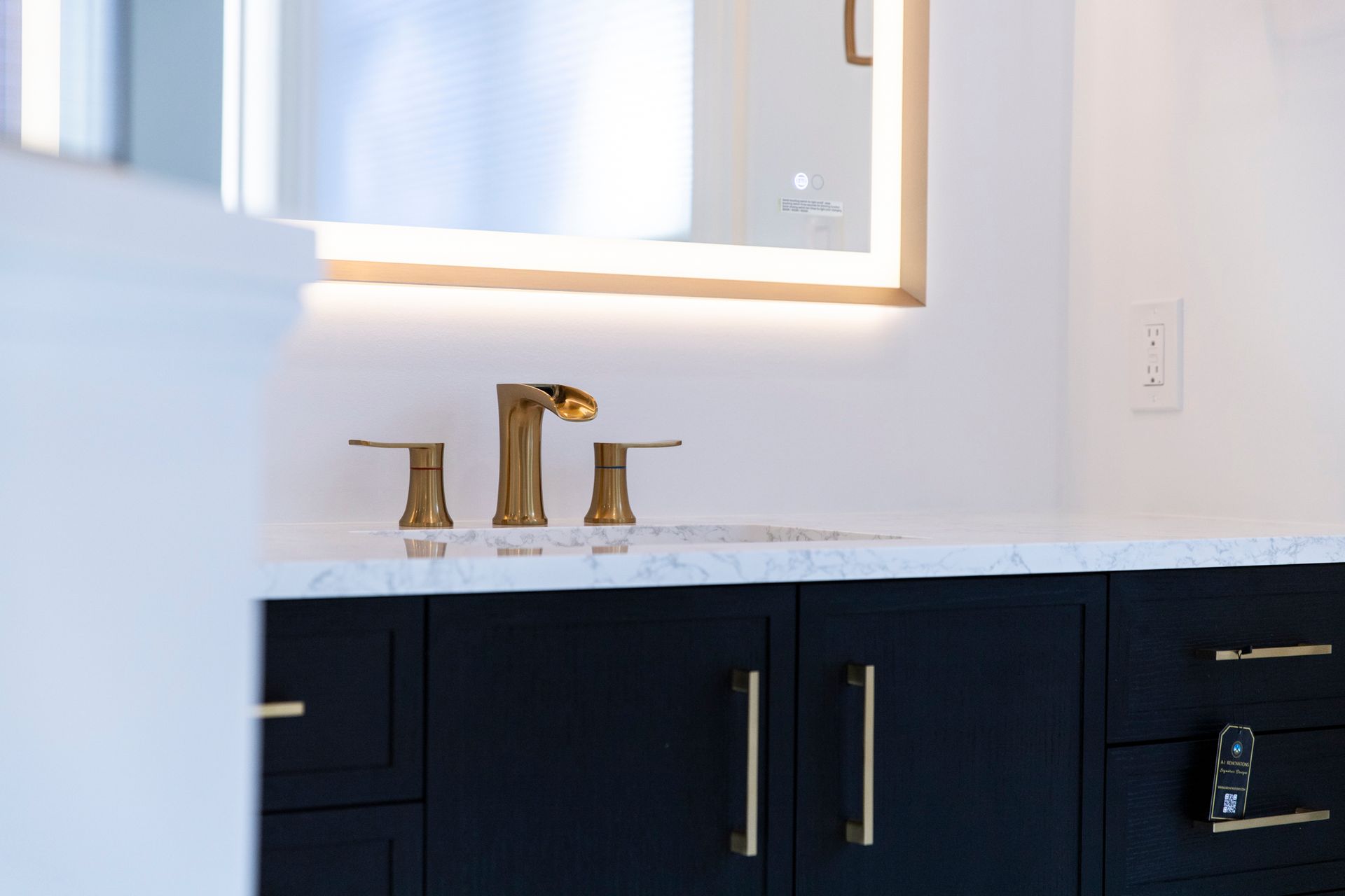 lose-up of the new vanity and marble countertop, showing the elegant gold faucets and handles in Cockeysville, MD.