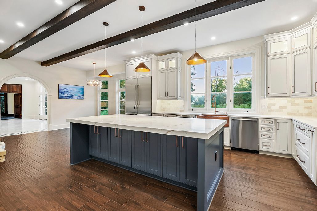 A wide shot of the renovated kitchen and living area, highlighting the seamless flow and cohesive design.