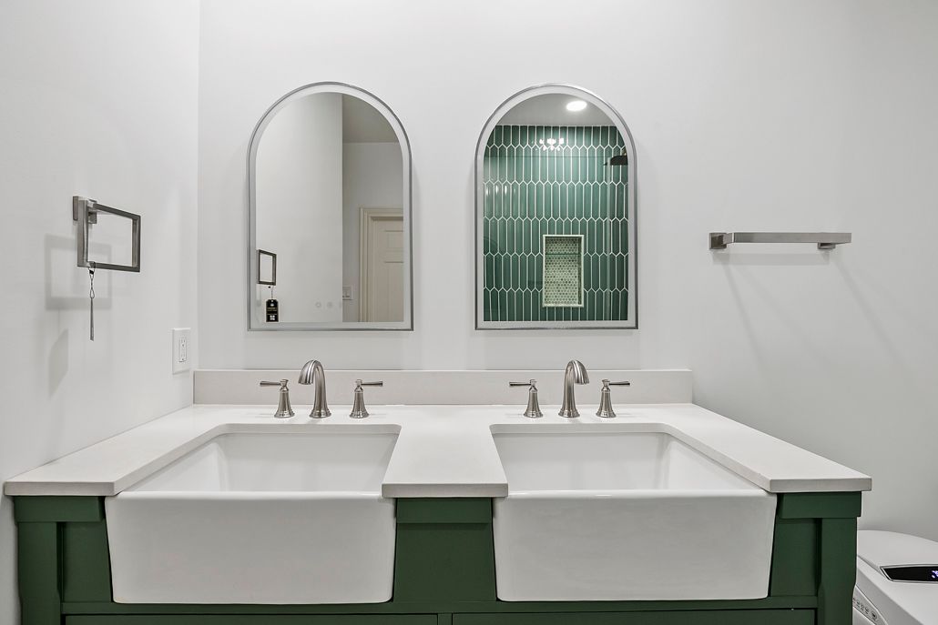 Expert installation of double farmhouse sinks and white quartz countertops, providing a functional and beautiful centerpiece for your master bath remodel.