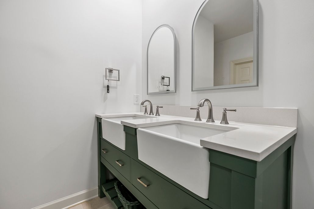 High-end fixture selection and installation, showcasing dual matte gray rain shower systems for a superior and spa-like shower experience.