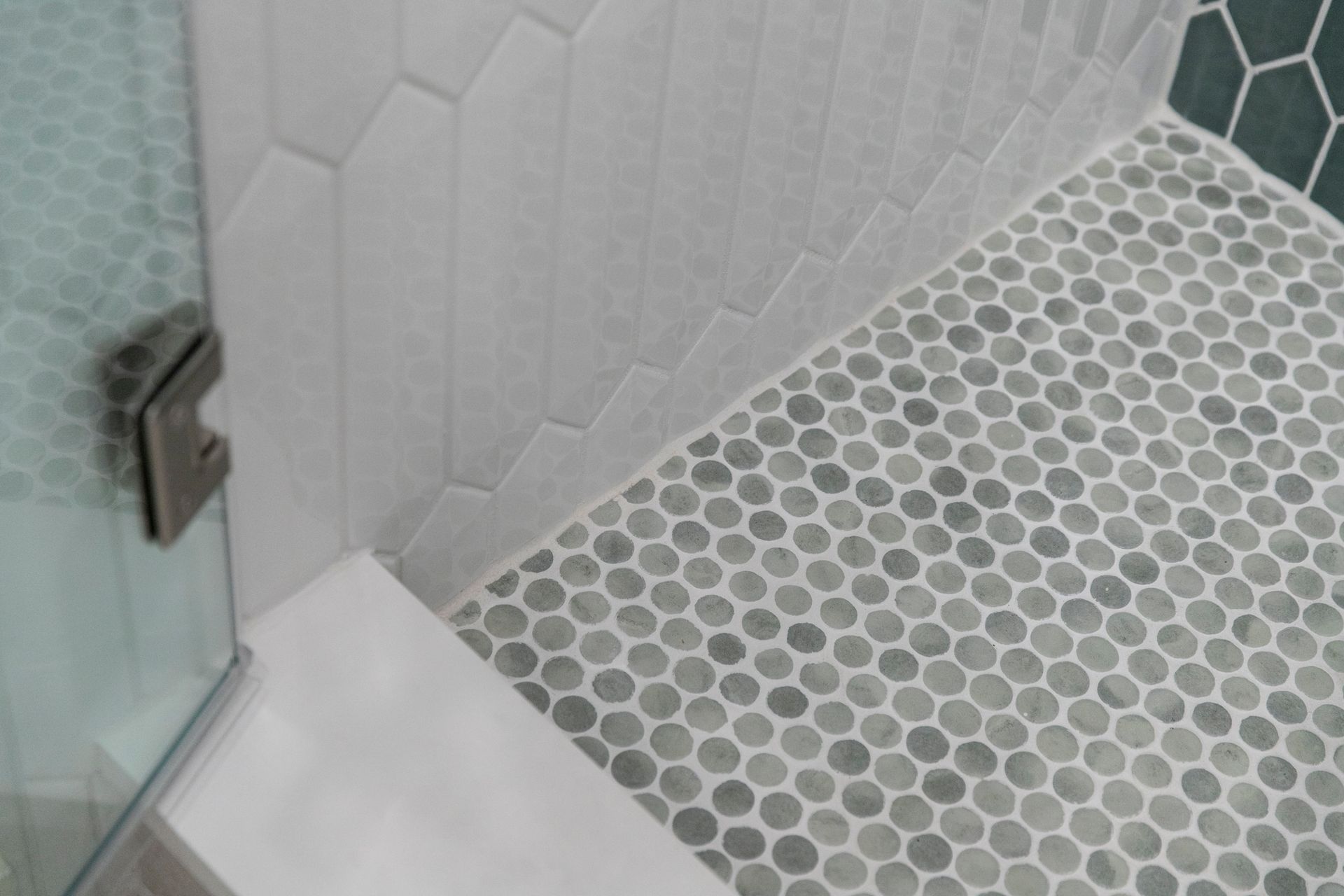 Showcase of advanced tile techniques, expertly blending white picket subway tile with contrasting colored vertical ceramic for dramatic effect.