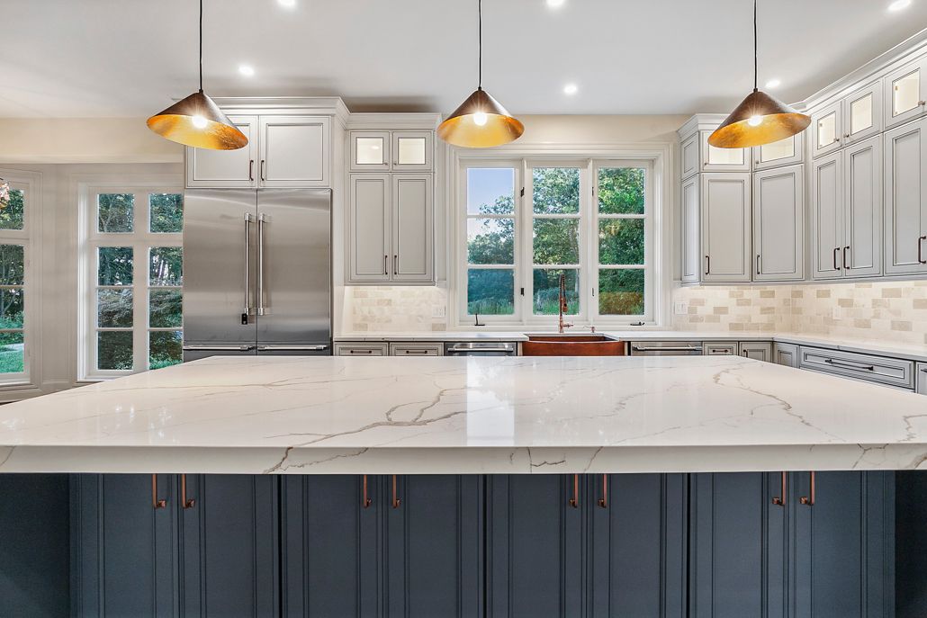 An elegant view of the living area with a newly updated fireplace and unified wood-look tile flooring.