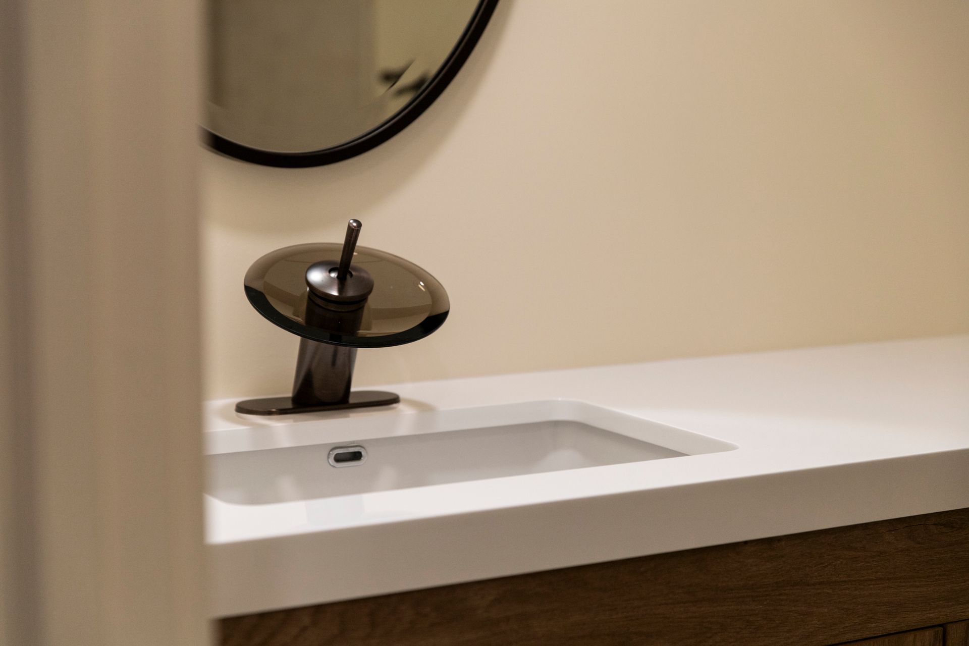 A close-up of the new faucet and sink, highlighting the unique design and modern black finish.
