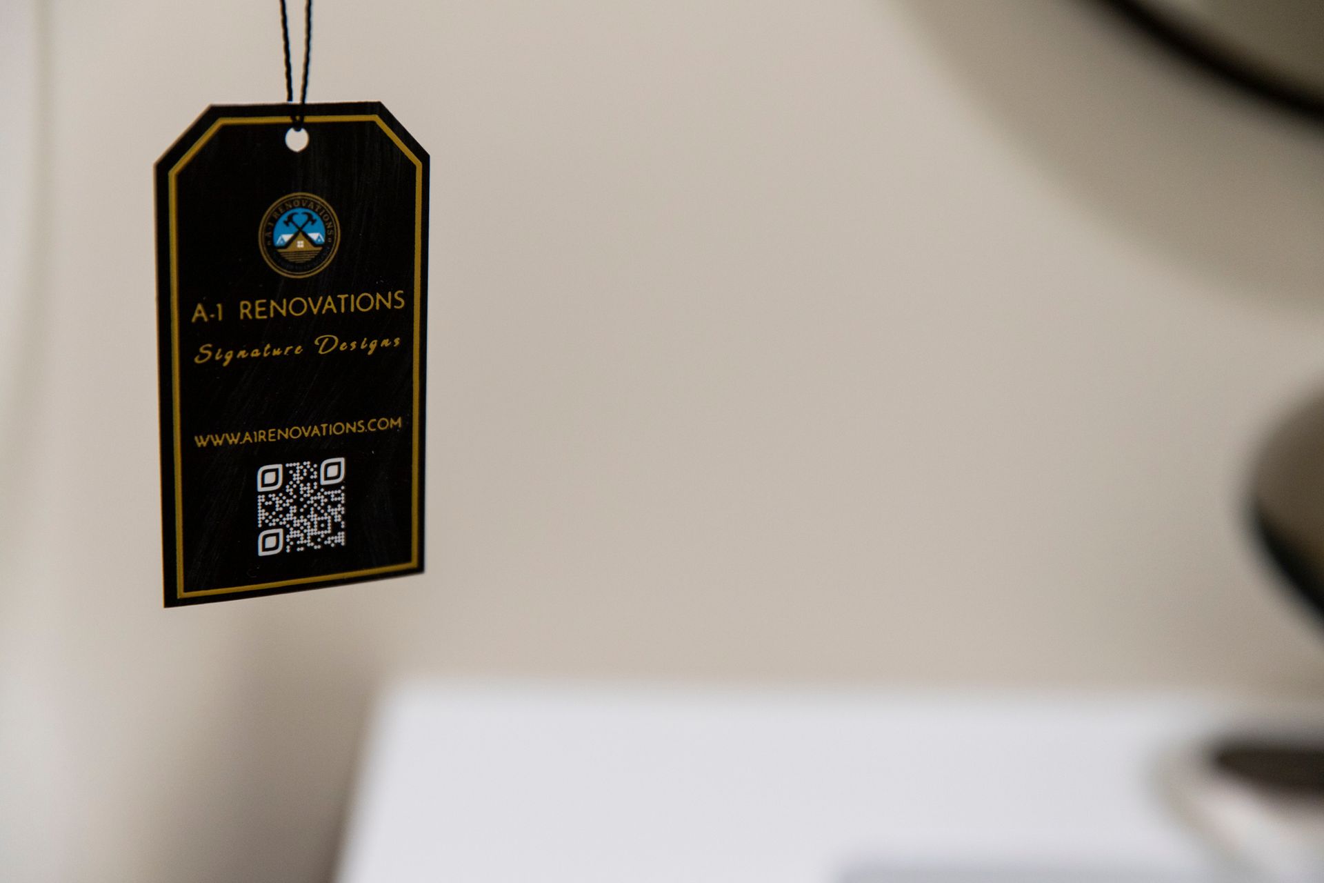 A close-up of a product tag from A-1 Renovations, highlighting the company's branding and website URL.