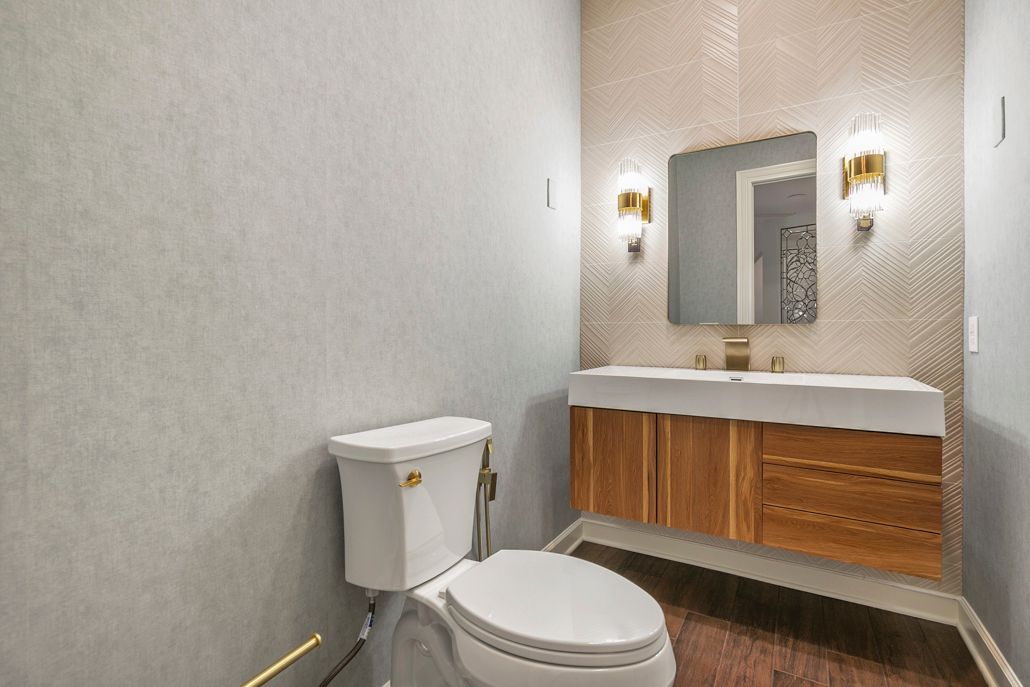 Full view of a modern powder room with new toilet and floating vanity.