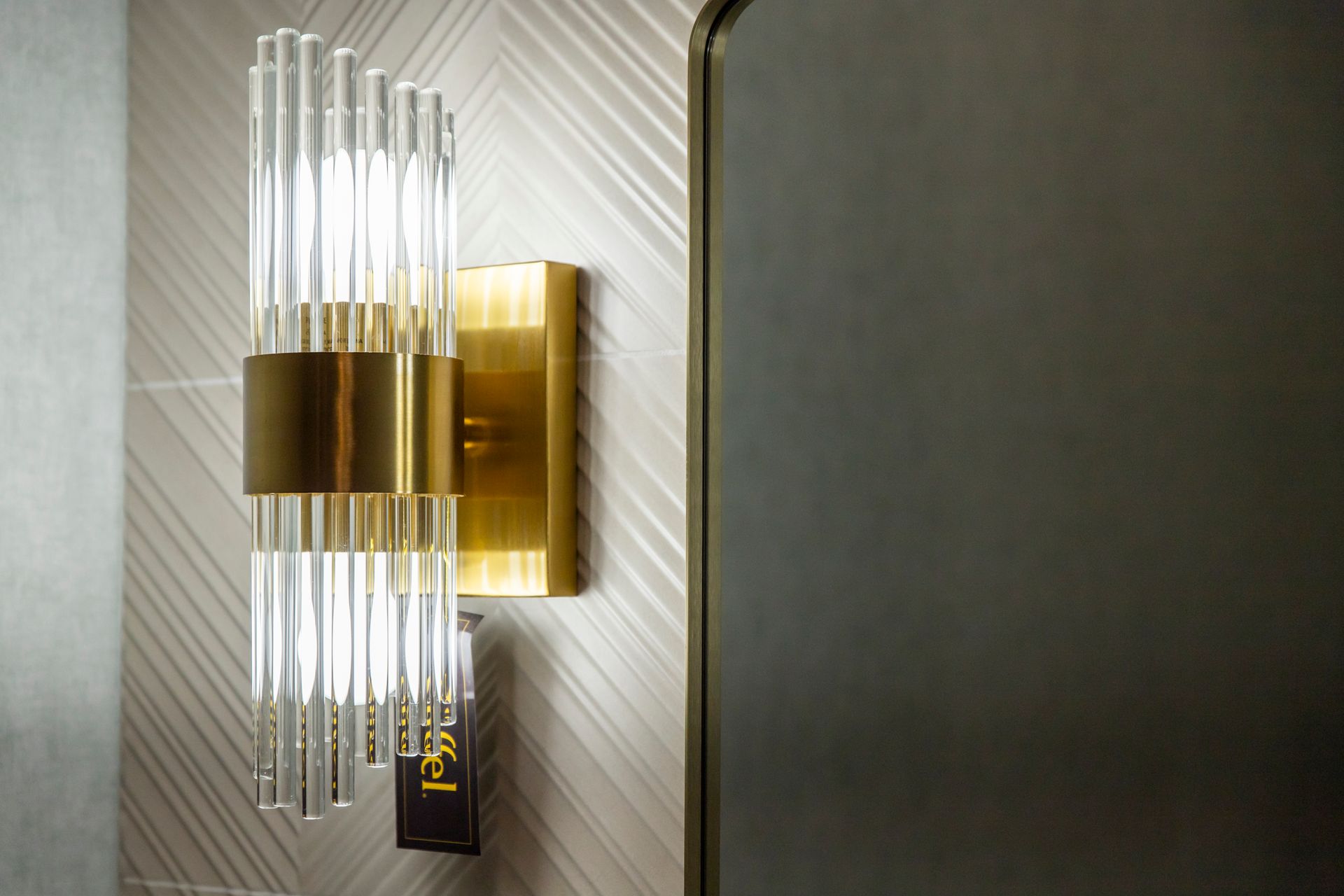 Modern gold and glass wall sconce.