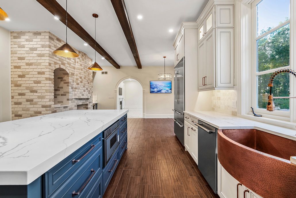 A professional shot of the home's new white granite countertops and a sleek, stainless steel stove.