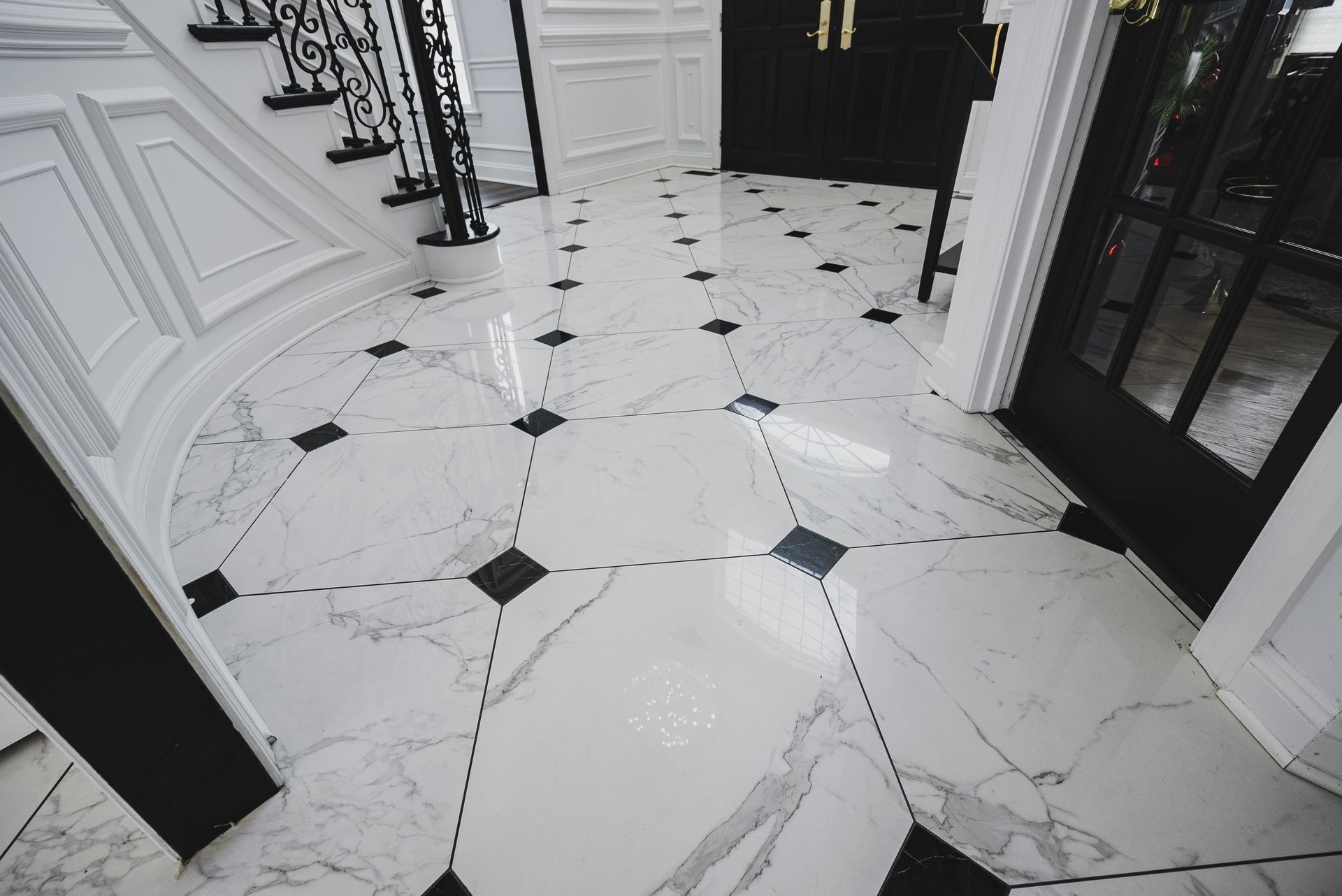 Bright and reflective marble flooring that enhances the natural light in a grand foyer.