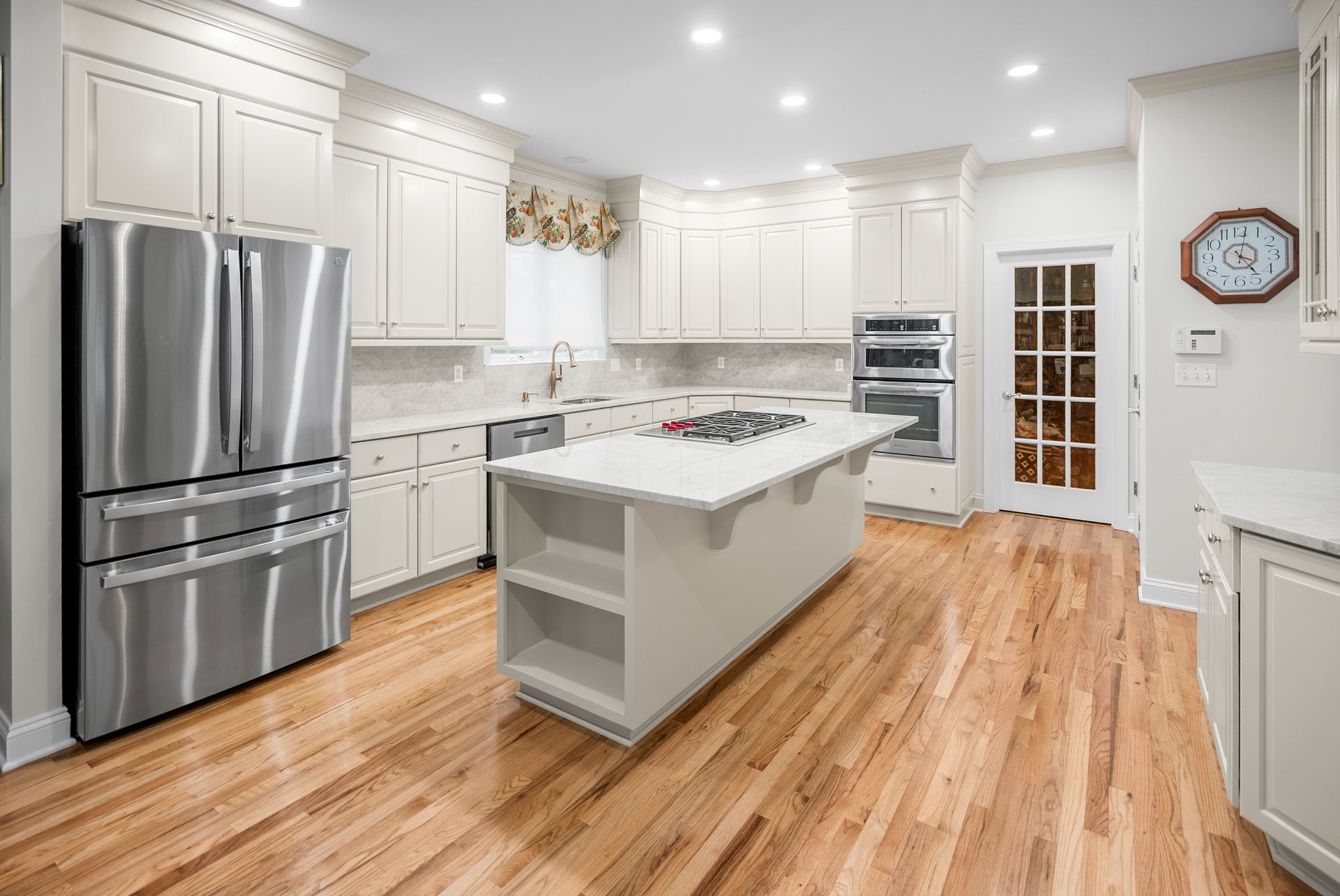 Custom kitchen island end cap featuring open display shelving and decorative side panels