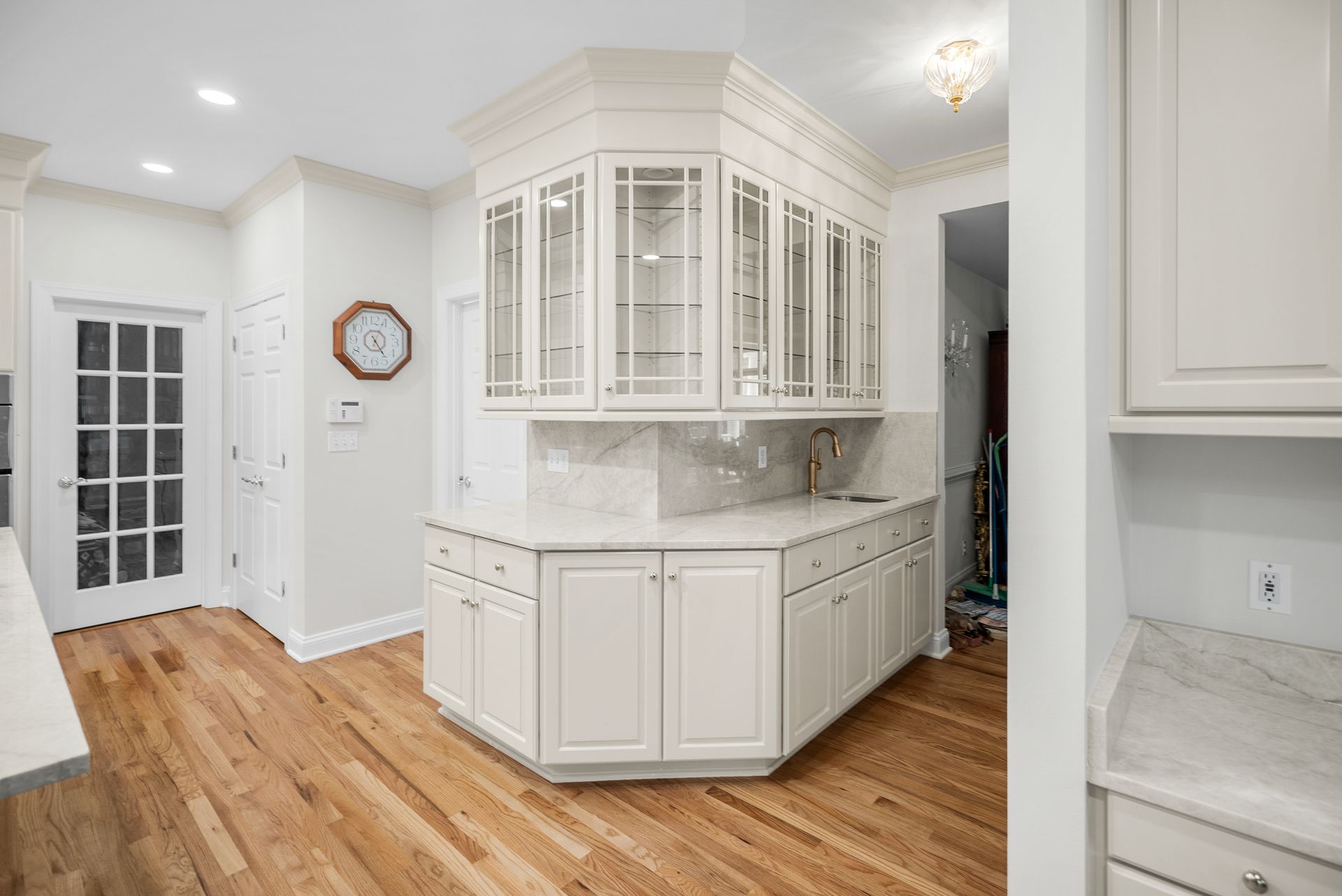 Built-in stainless steel double wall ovens set inside custom off-white kitchen cabinetry