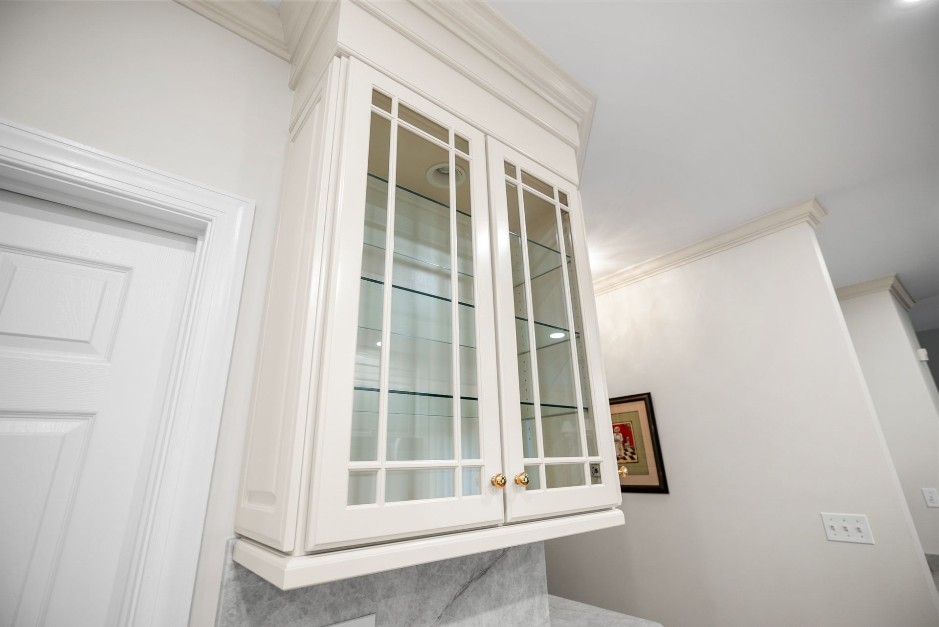Modern luxury kitchen transformation featuring custom off-white cabinetry and floor-to-ceiling crown molding