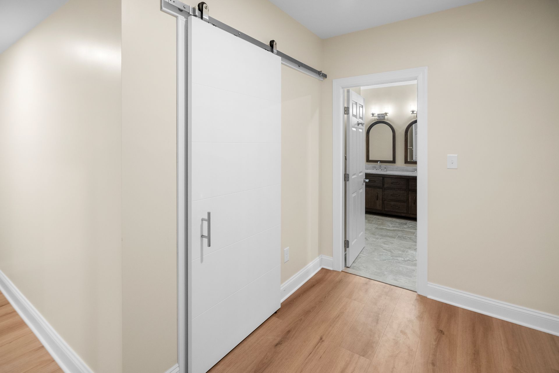 Carpeted basement stairwell leading smoothly into a bright, finished lower-level living space.