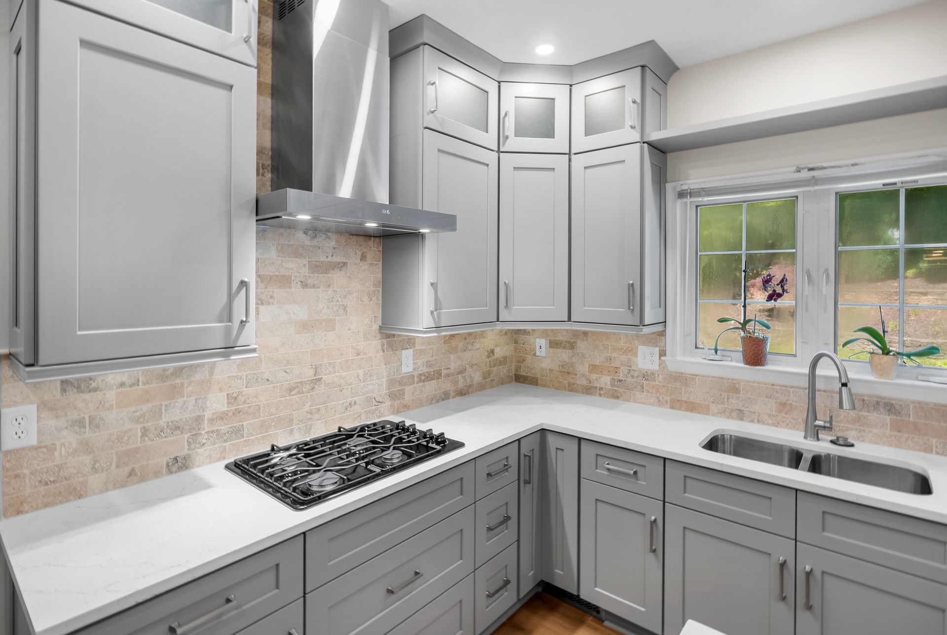 Luxury entertaining kitchen design in Lutherville-Timonium featuring a waterfall island by A-1 Renovations.