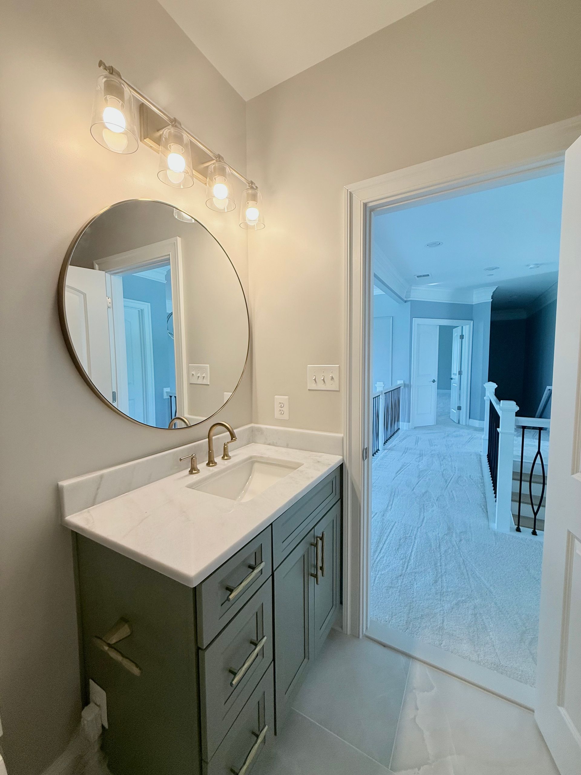New bathroom with a custom walk-in shower and a modern green vanity.