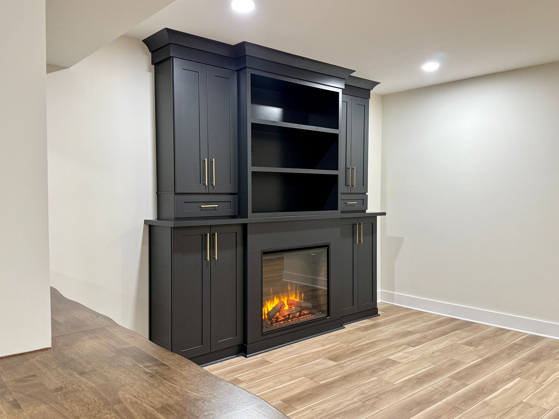 Modern basement finishing with charcoal accent wall and built-in shelving.