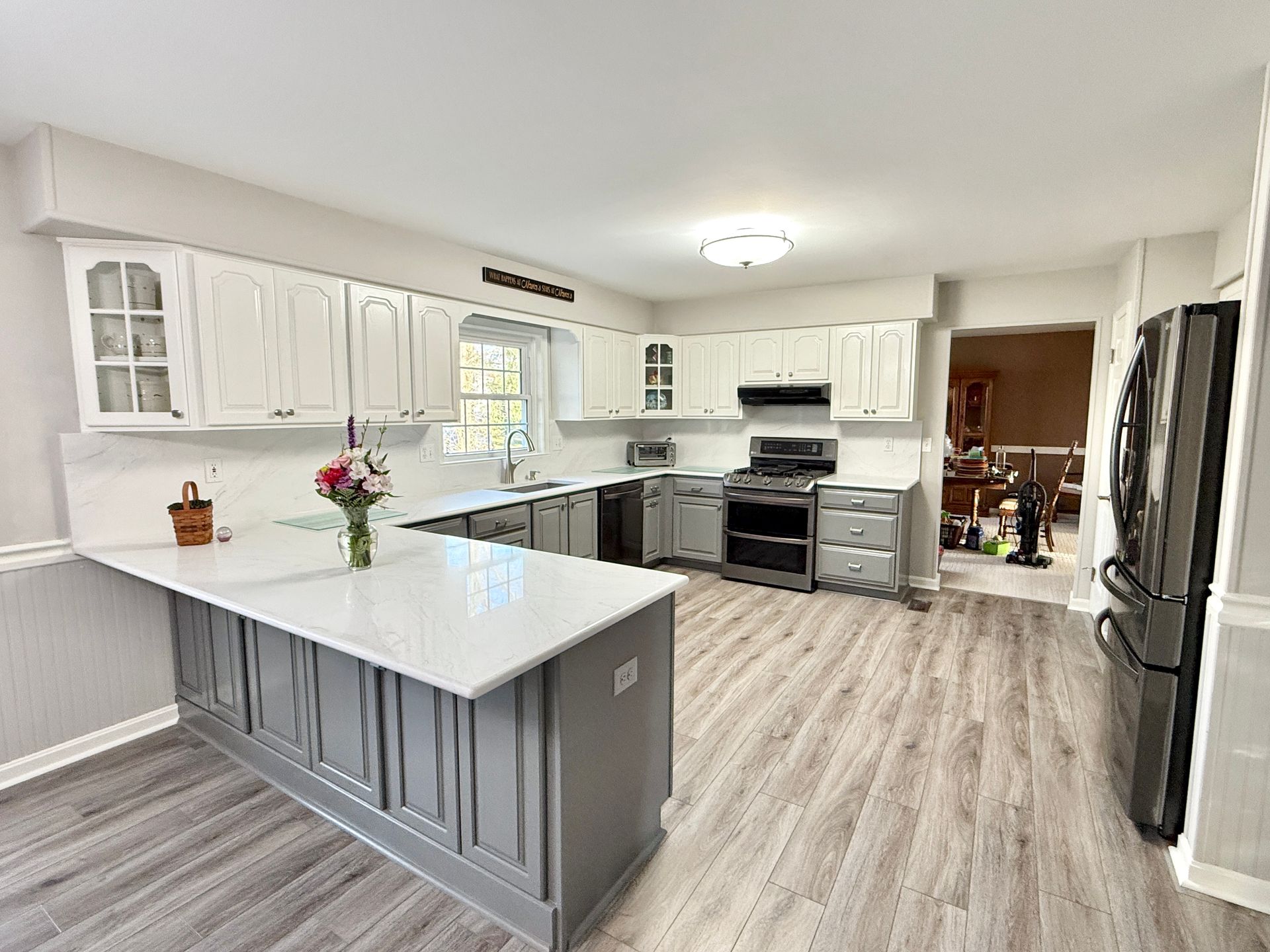 A complete modern update featuring two-tone cabinets and quartz surfaces.