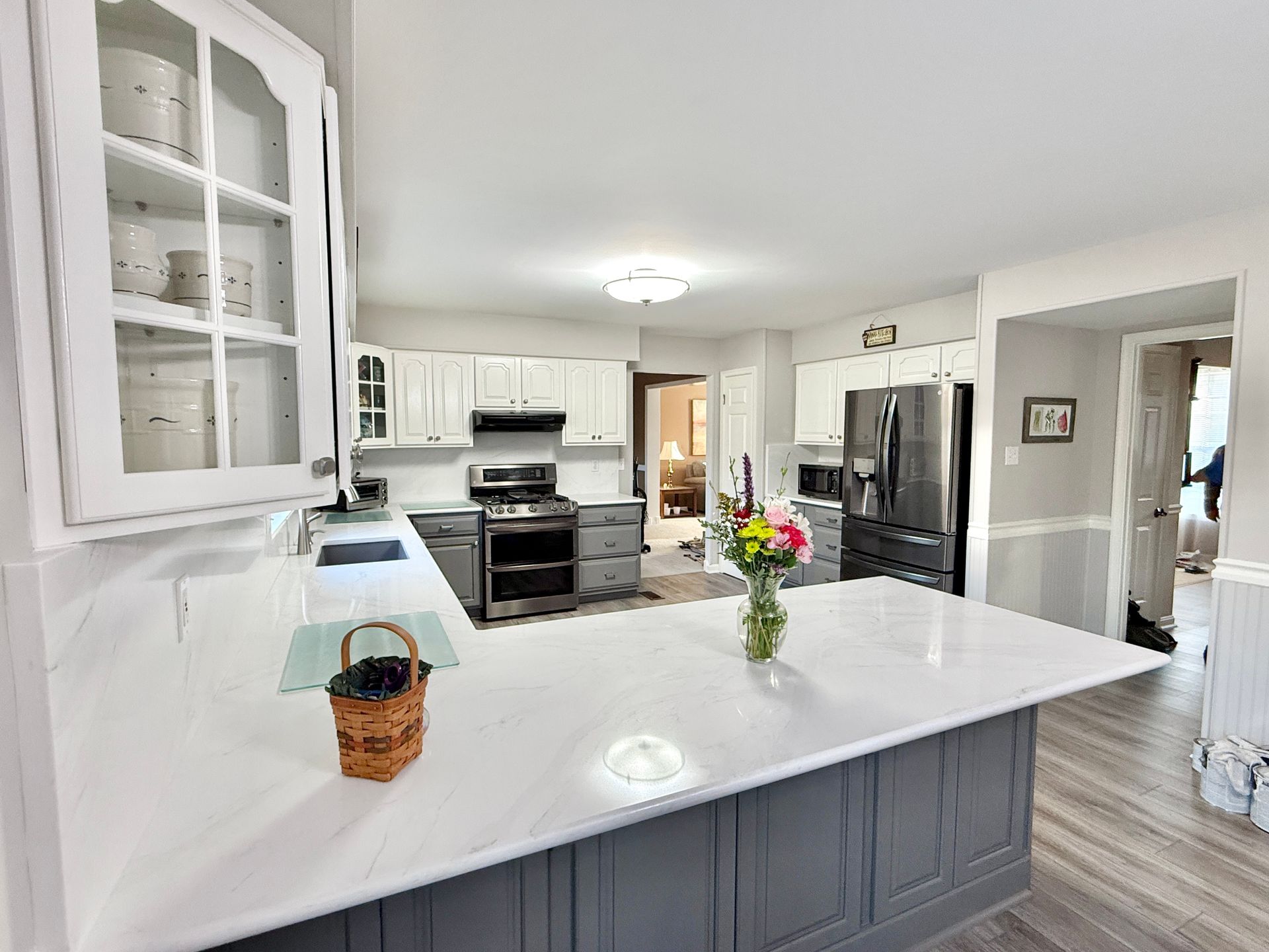 Seamless kitchen design using the same quartz stone for countertops and walls.