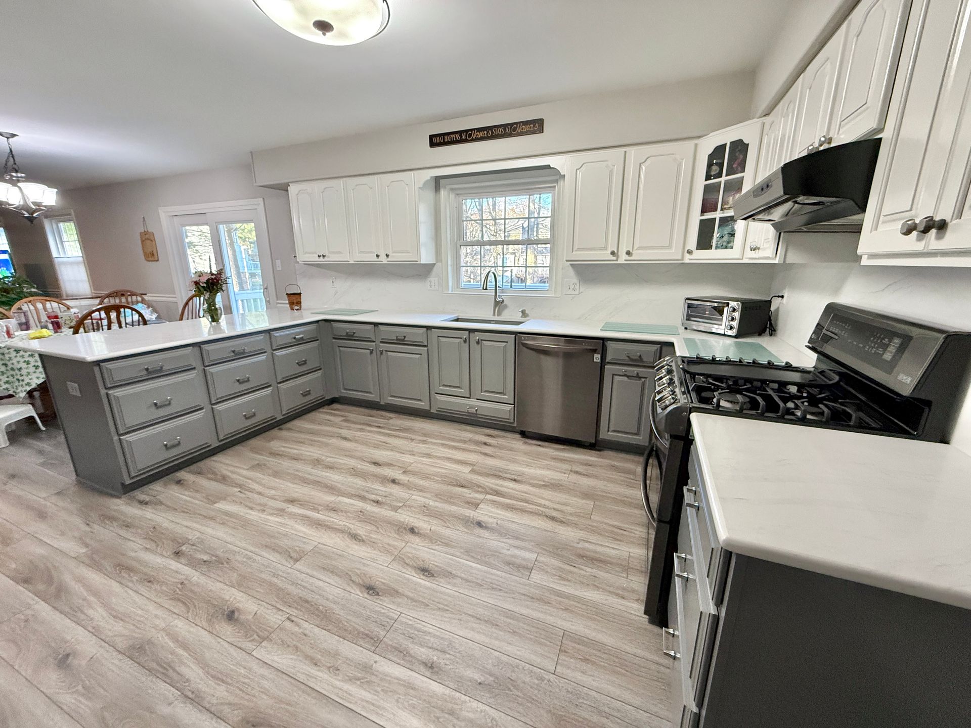 Bright white upper cabinets contrasted with charcoal grey base cabinets.